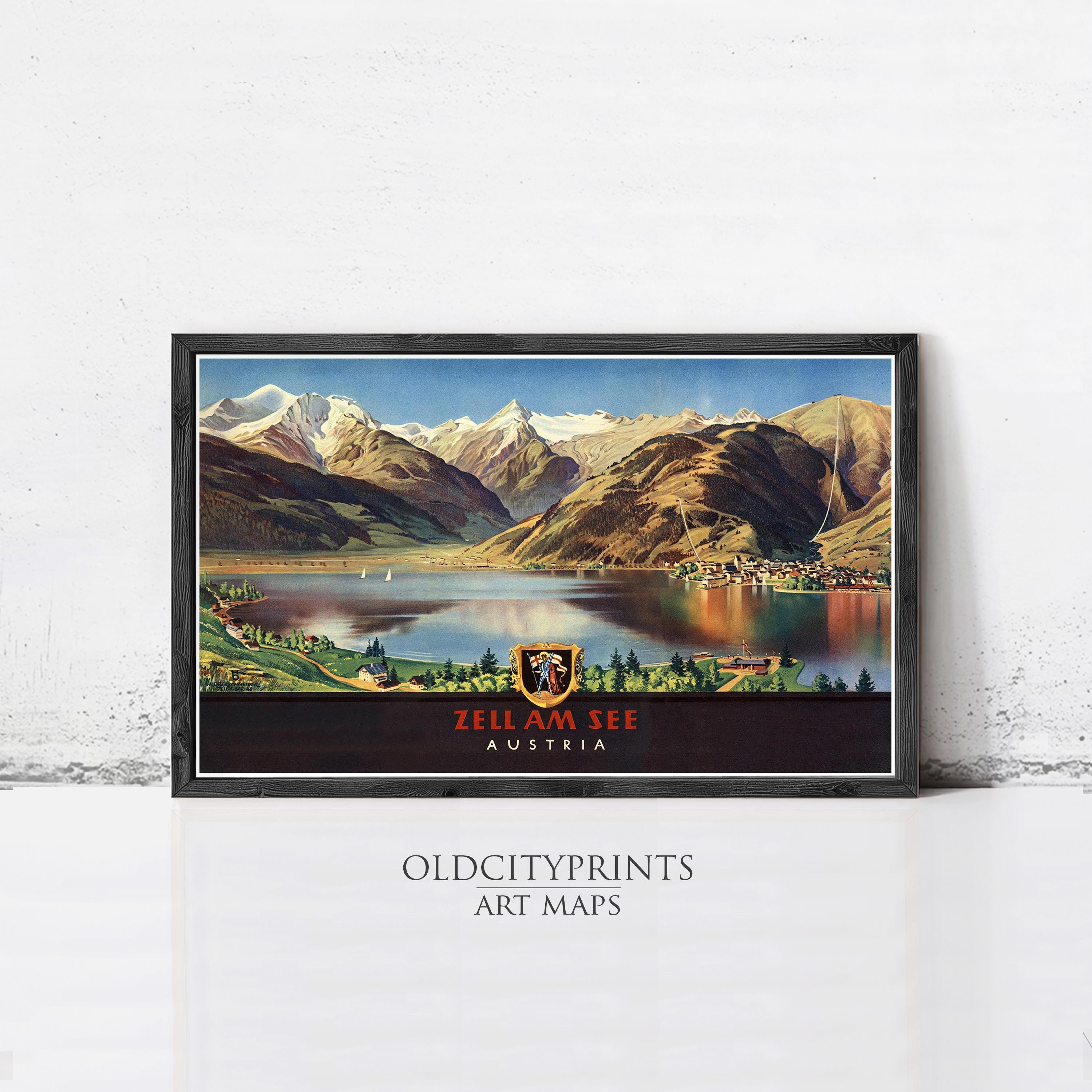 A framed vintage travel poster depicting a scenic mountain landscape with a lake and a town in the foreground, with the text "ZELL AM SEE AUSTRIA" prominently displayed.