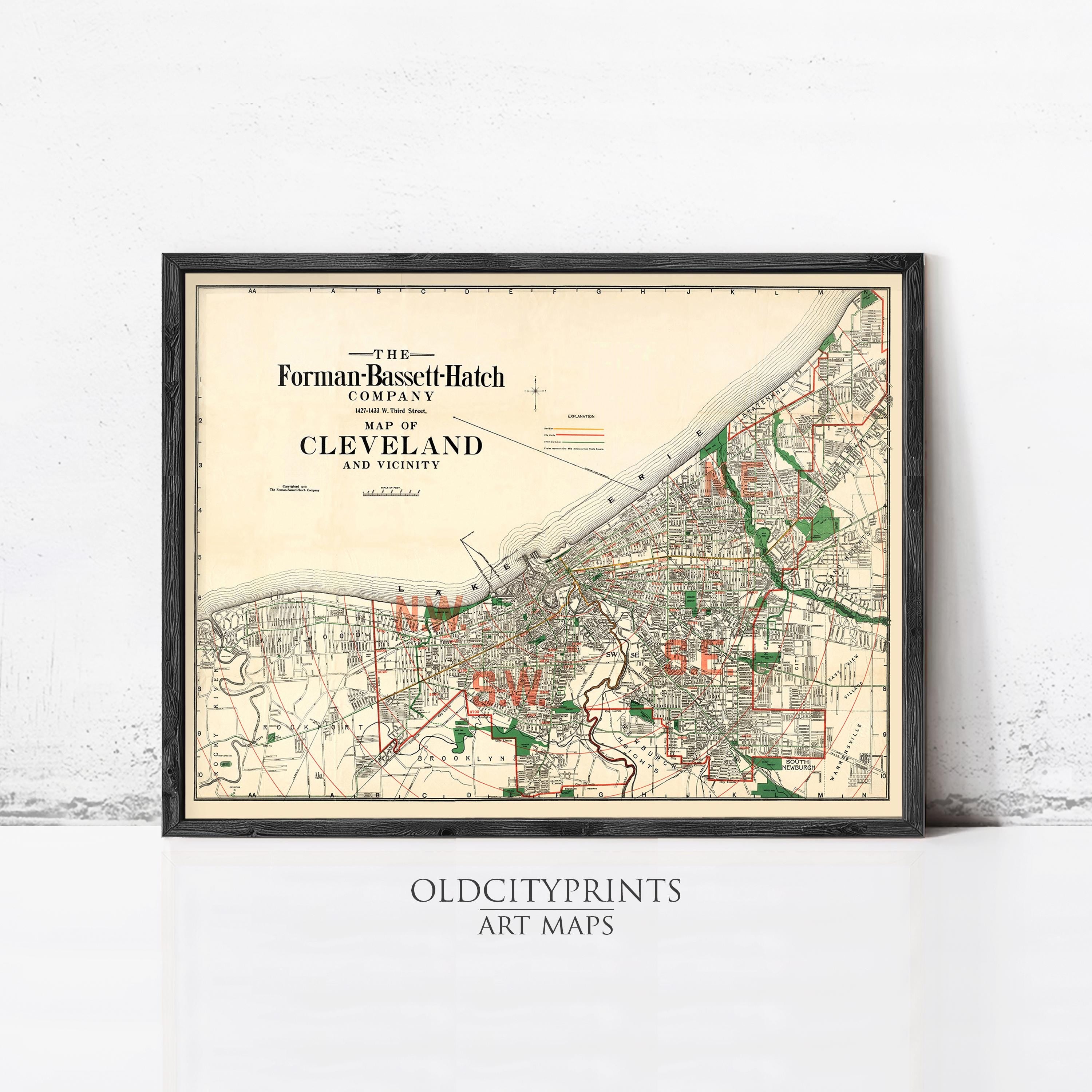 The image is a framed vintage map of Cleveland, Ohio, depicting the city's streets and surrounding areas.