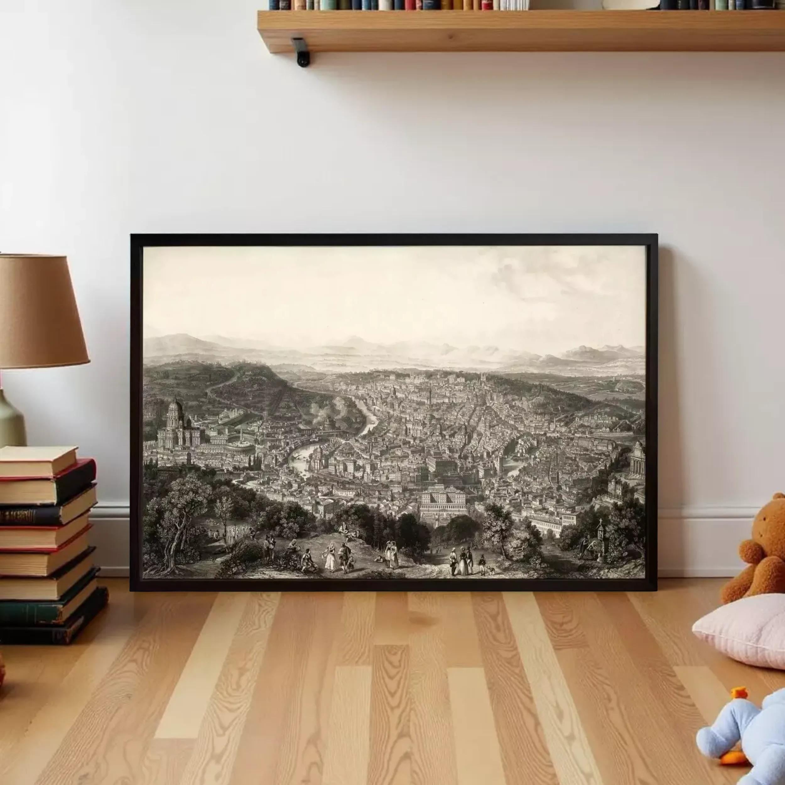 a large framed black and white illustration of a cityscape, displayed on a wooden floor in a room with a bookshelf and a teddy bear.