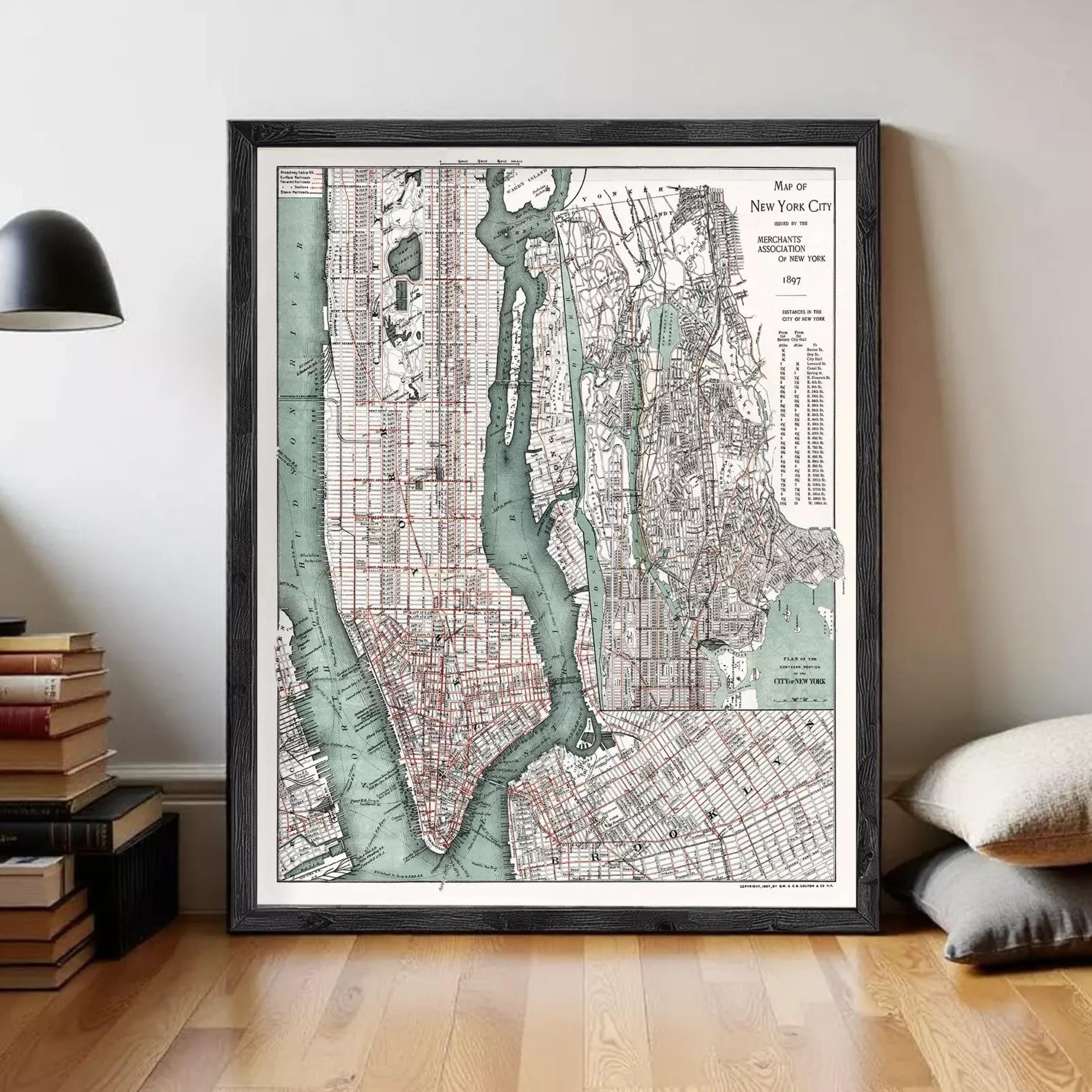 The image is a framed vintage map of New York City, depicting the city's streets, waterways, and surrounding areas.