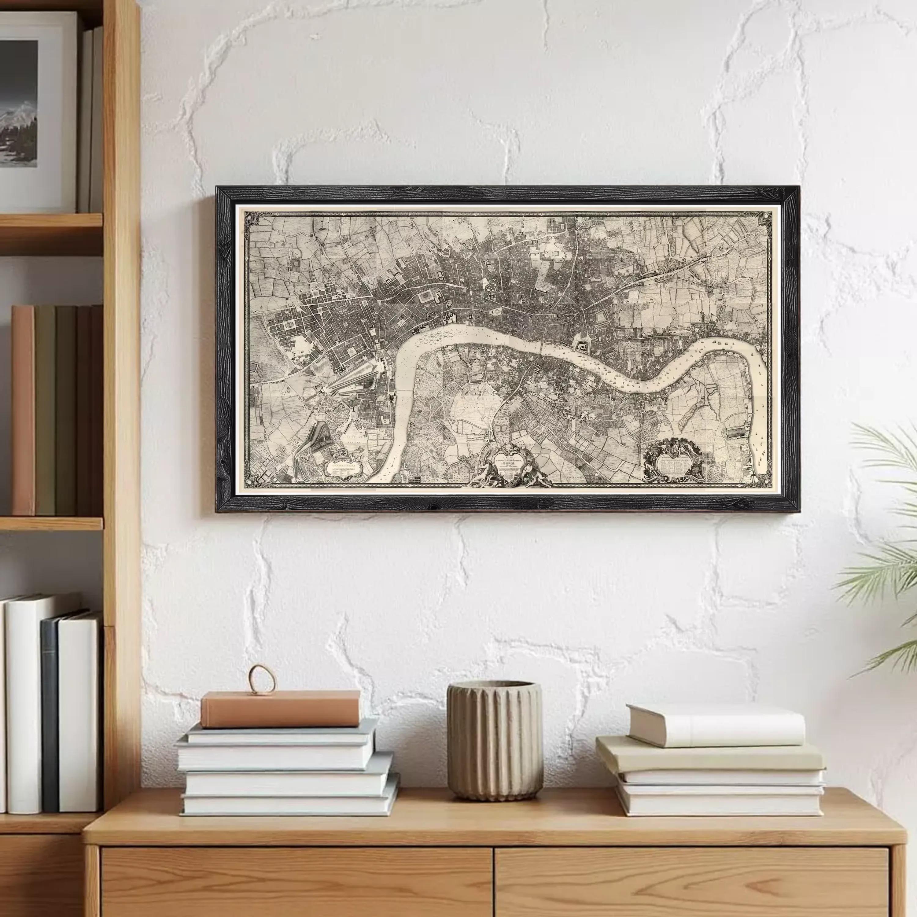 a framed map of London hanging on a wall above a wooden dresser. The dresser has a stack of books and a vase on it.