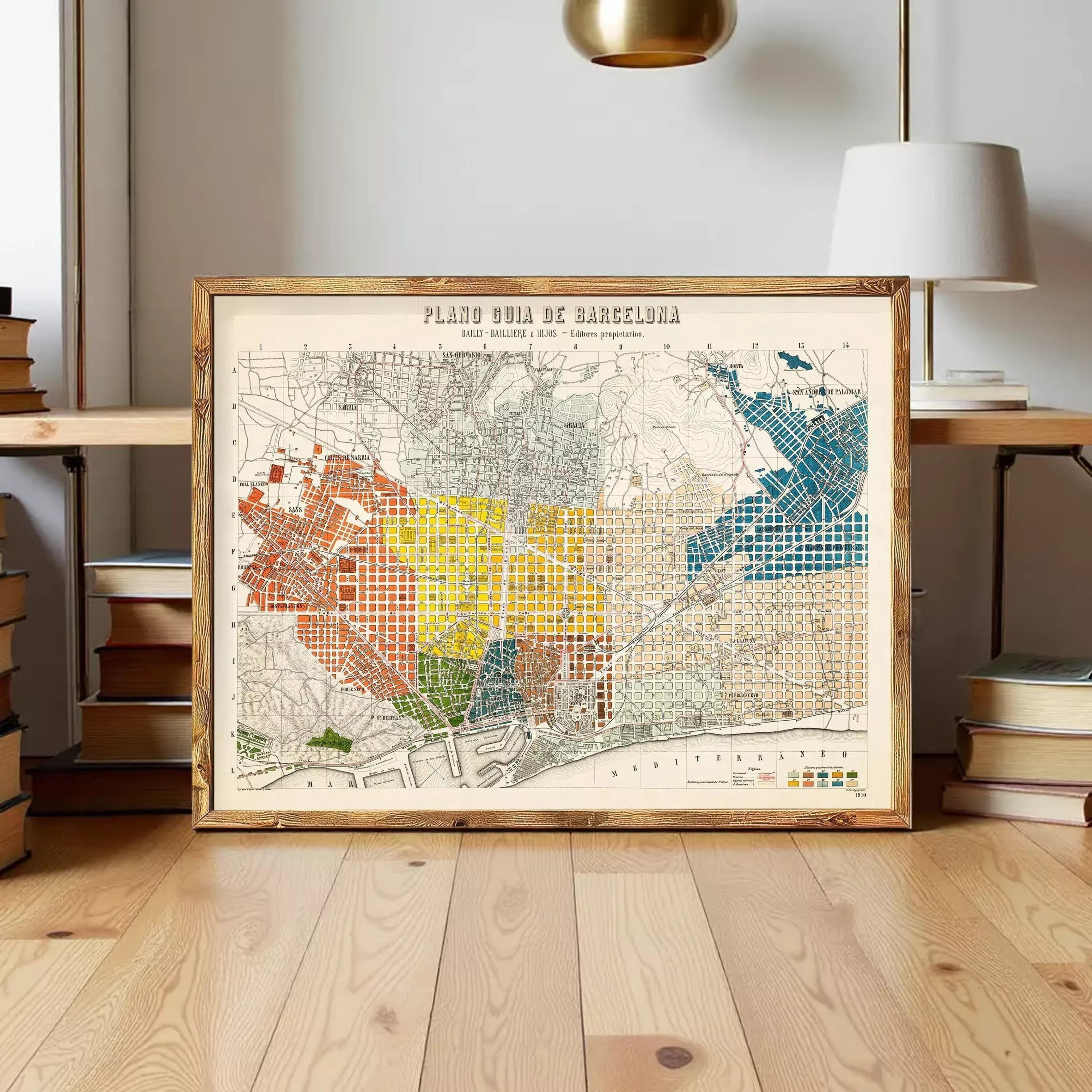 a framed map of Barcelona, Spain, with a wooden floor and a lamp in the background.