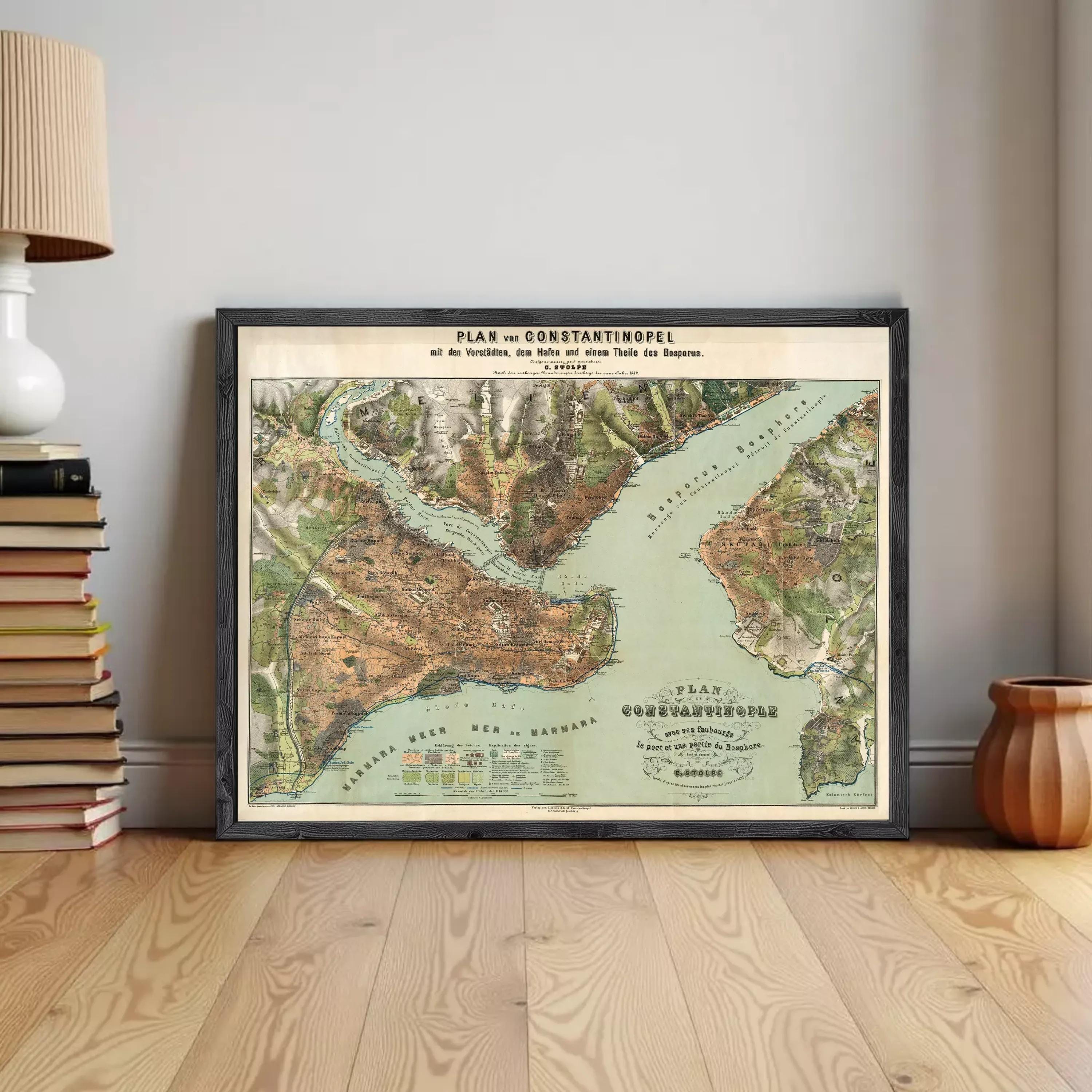 a framed map of the Bosphorus Strait, which is a significant geographical feature in Europe. The map is displayed on a wooden floor, and there are several books and a lamp in the background.