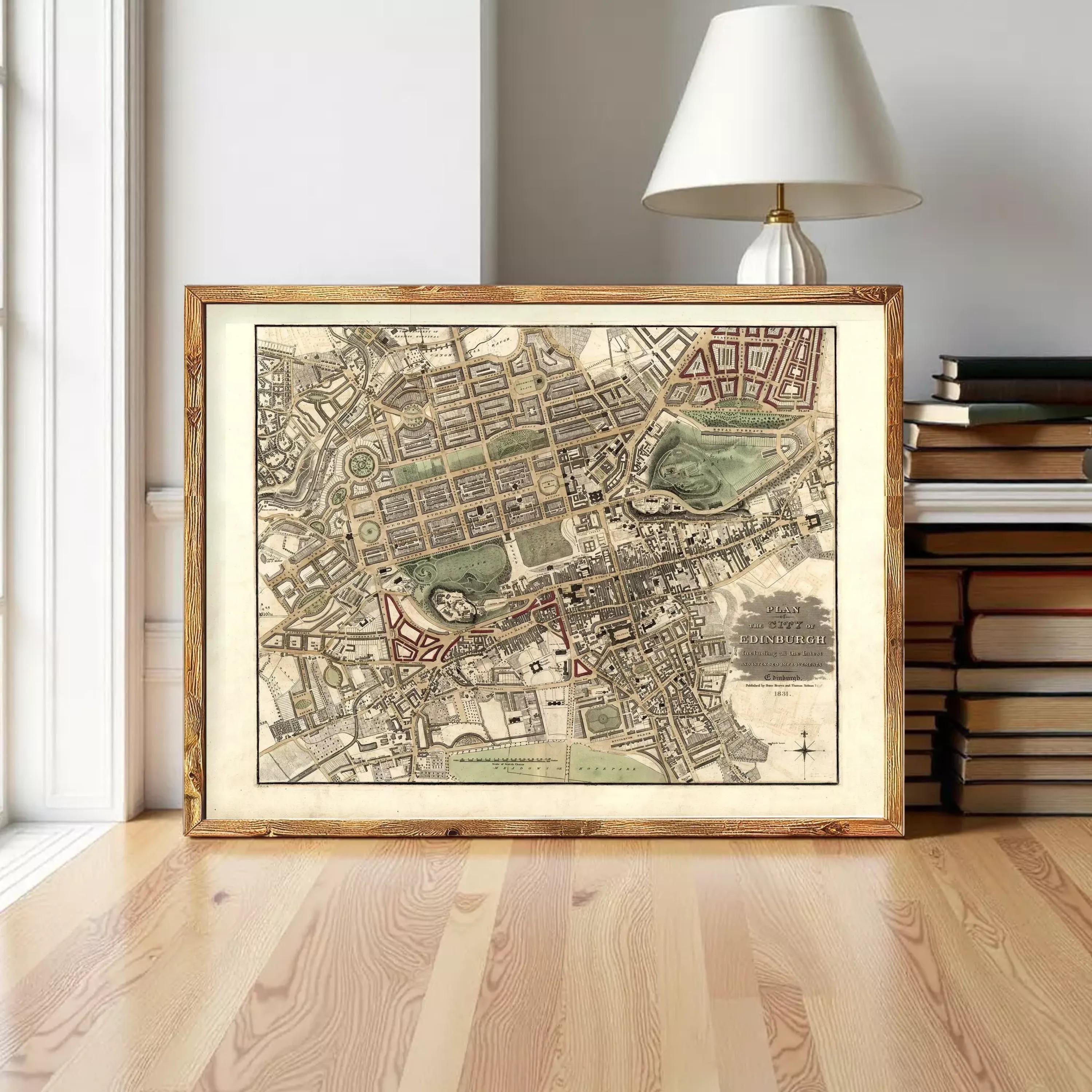 A framed map of a city is displayed on a wooden floor, with a lamp and bookshelf visible in the background.