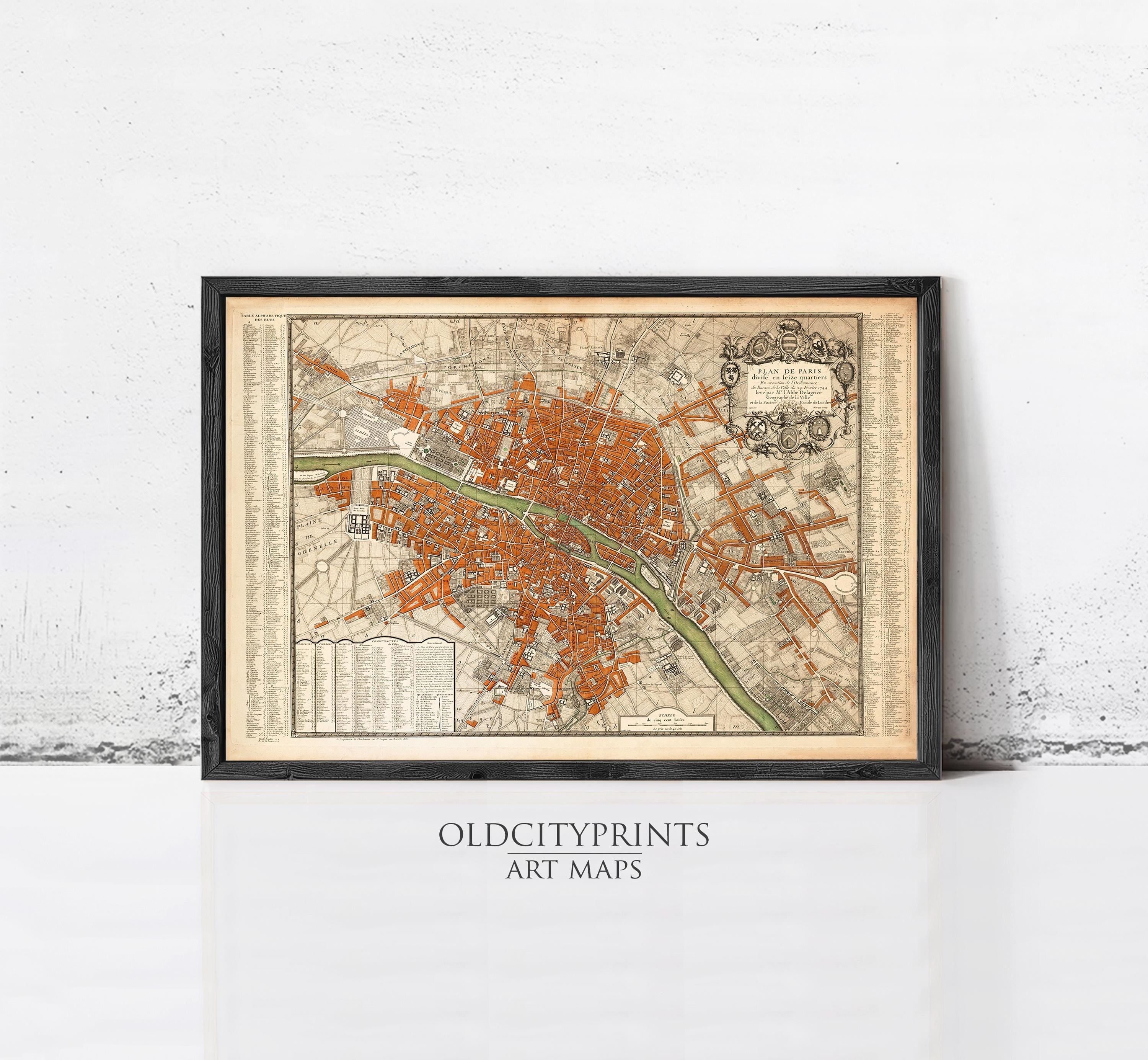 The image is a framed vintage map of a city, likely Paris, with a detailed and intricate design.