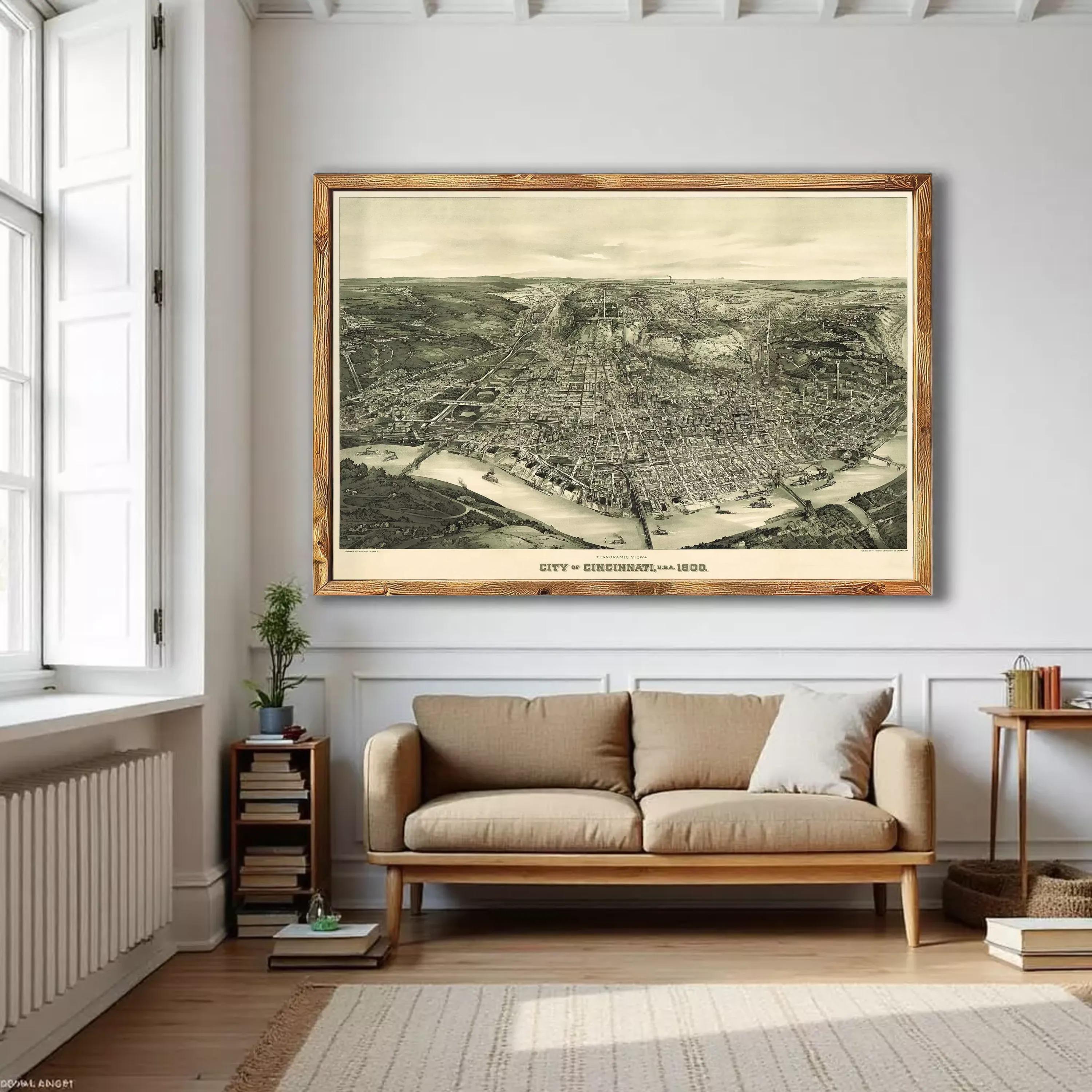a large framed aerial map of Cincinnati, Ohio, hanging on a wall in a living room.