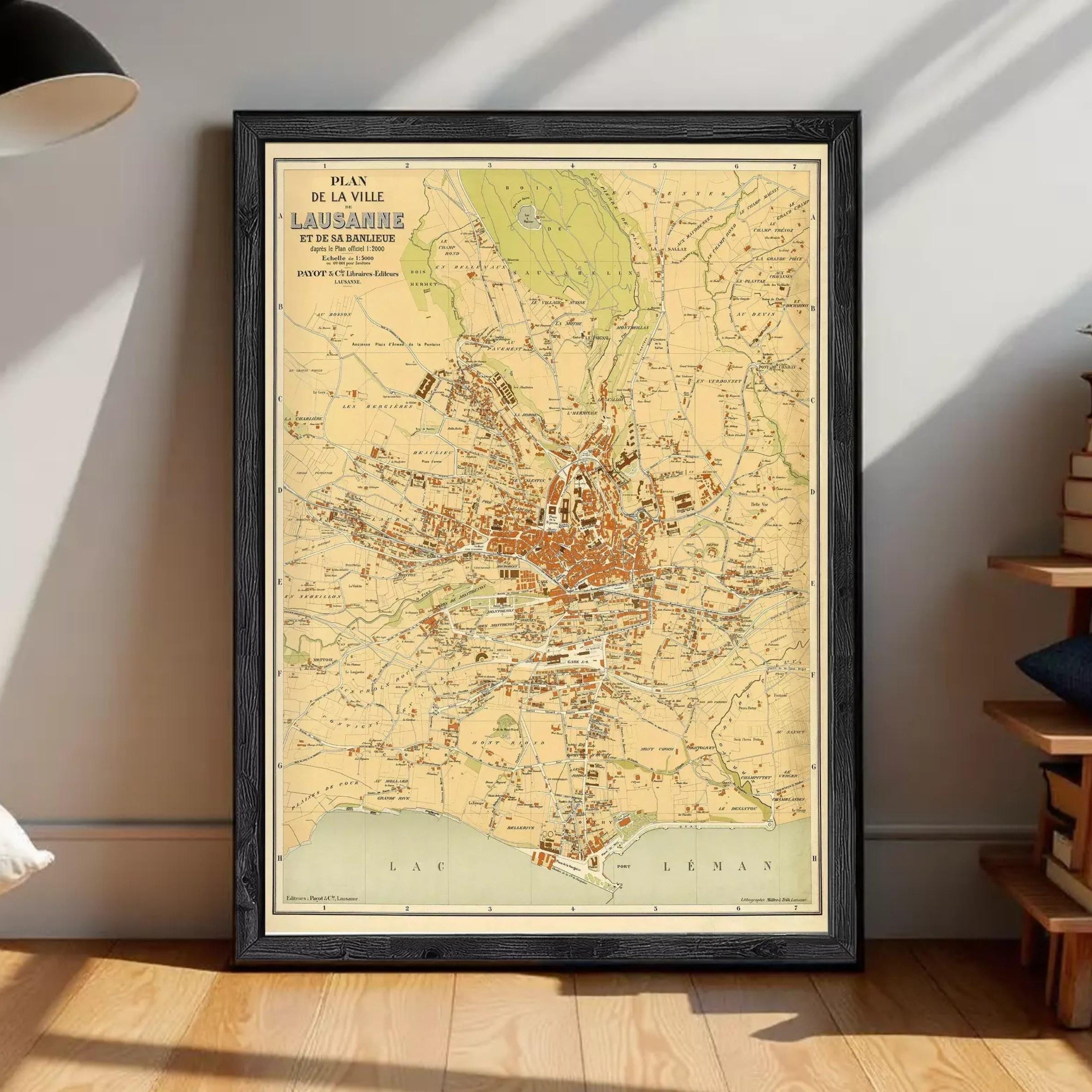 The image is a framed vintage map of the city of Lausanne, Switzerland, depicting the city's layout and surrounding areas.