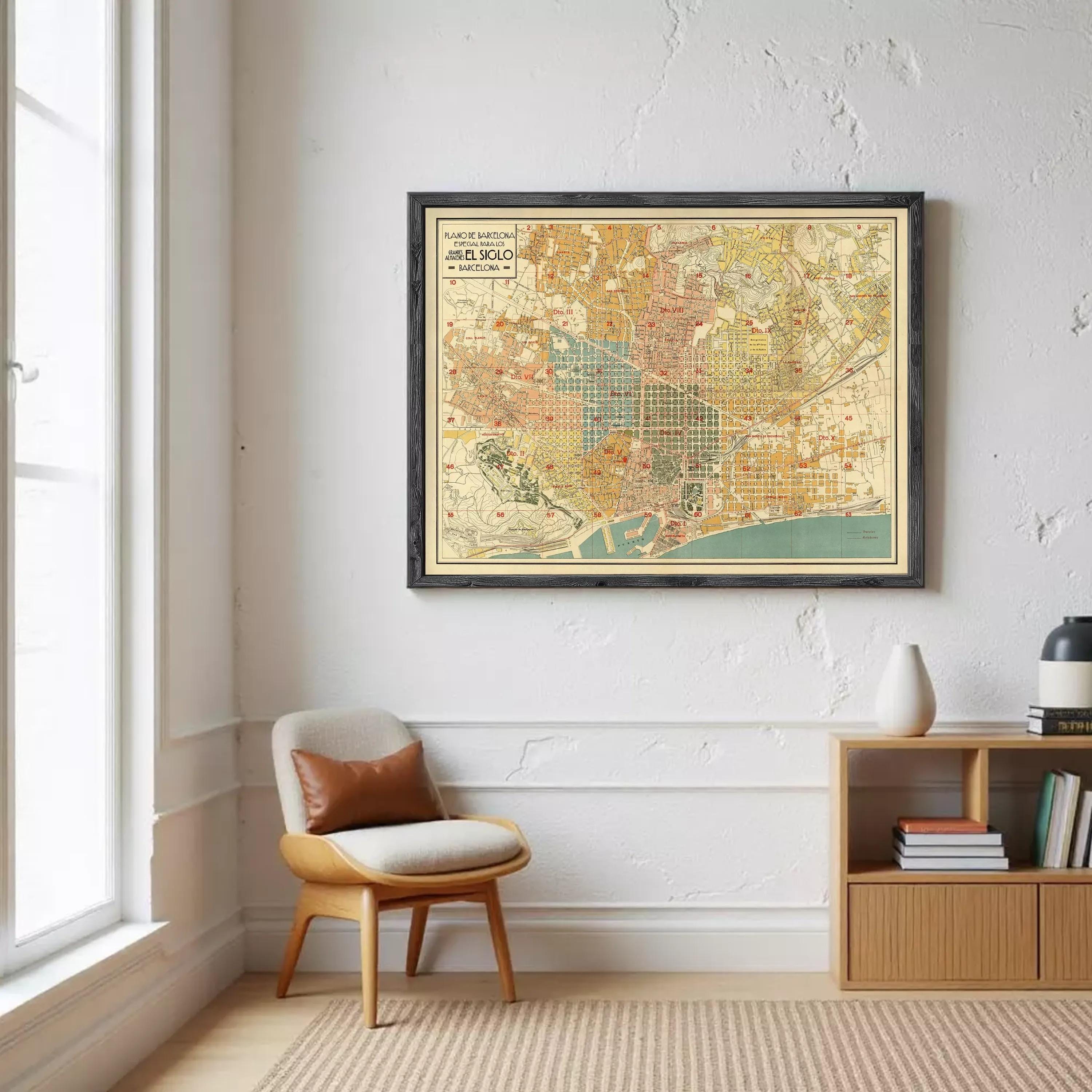 a framed vintage map of Barcelona hanging on a wall in a room with a wooden chair and a bookshelf.
