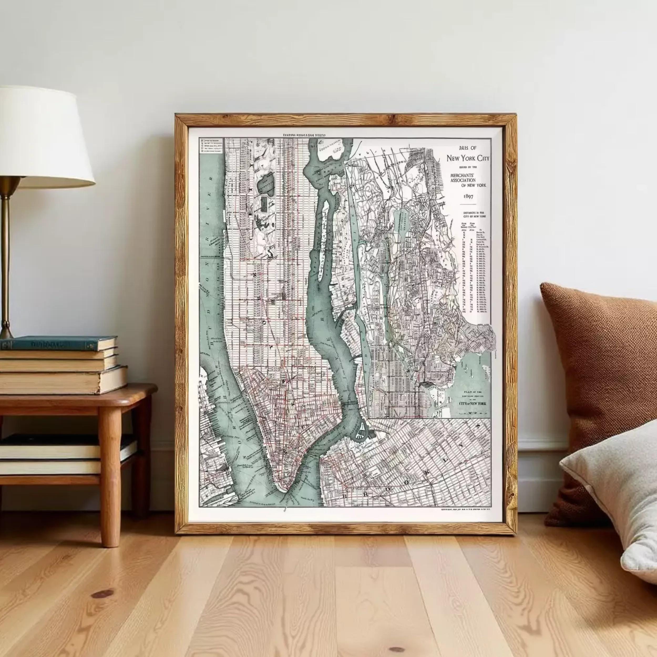 a framed map of New York City, with a wooden floor and a lamp visible in the background.