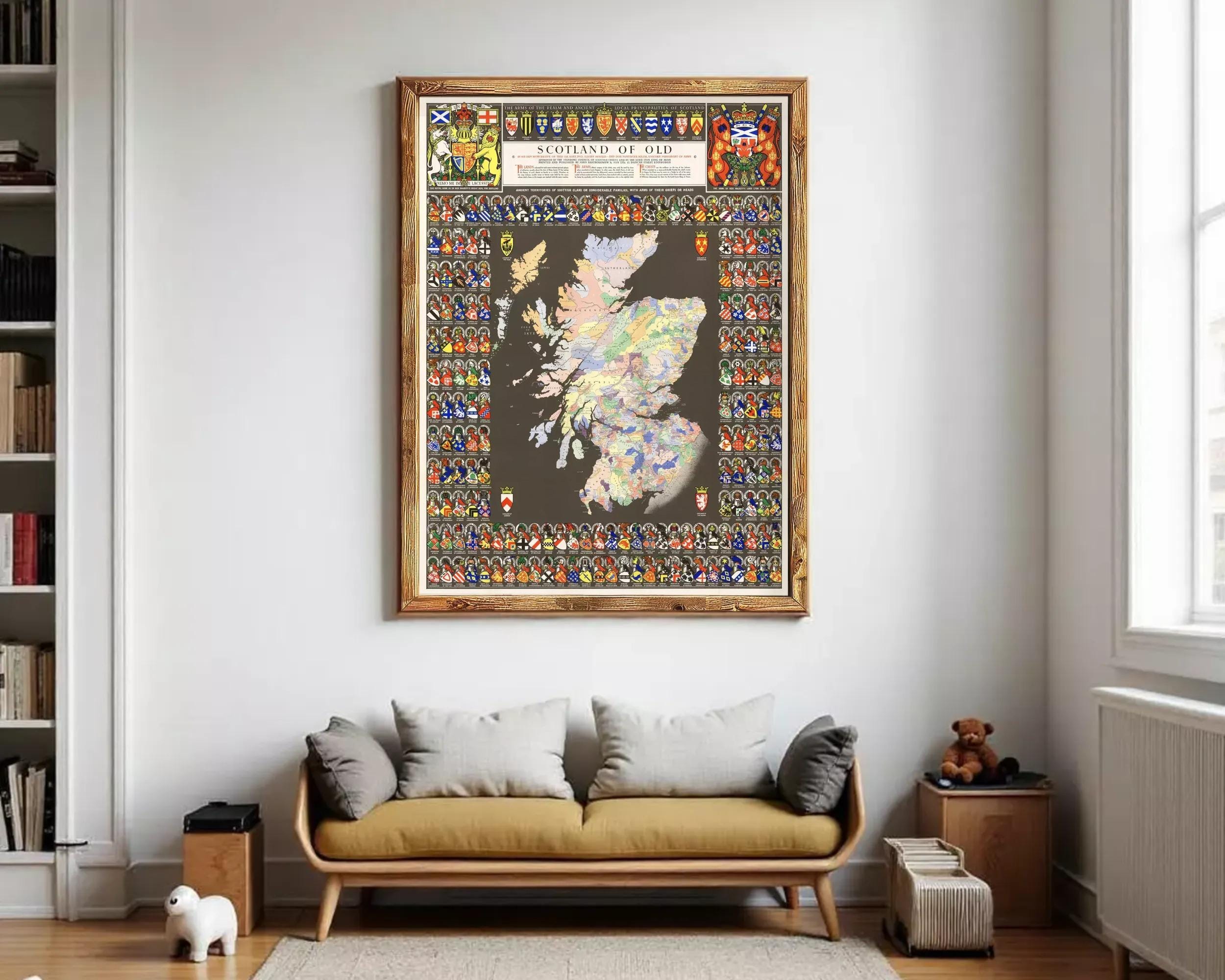 The image is a framed map of Scotland, featuring a variety of symbols and coat of arms representing different regions and groups within the country.