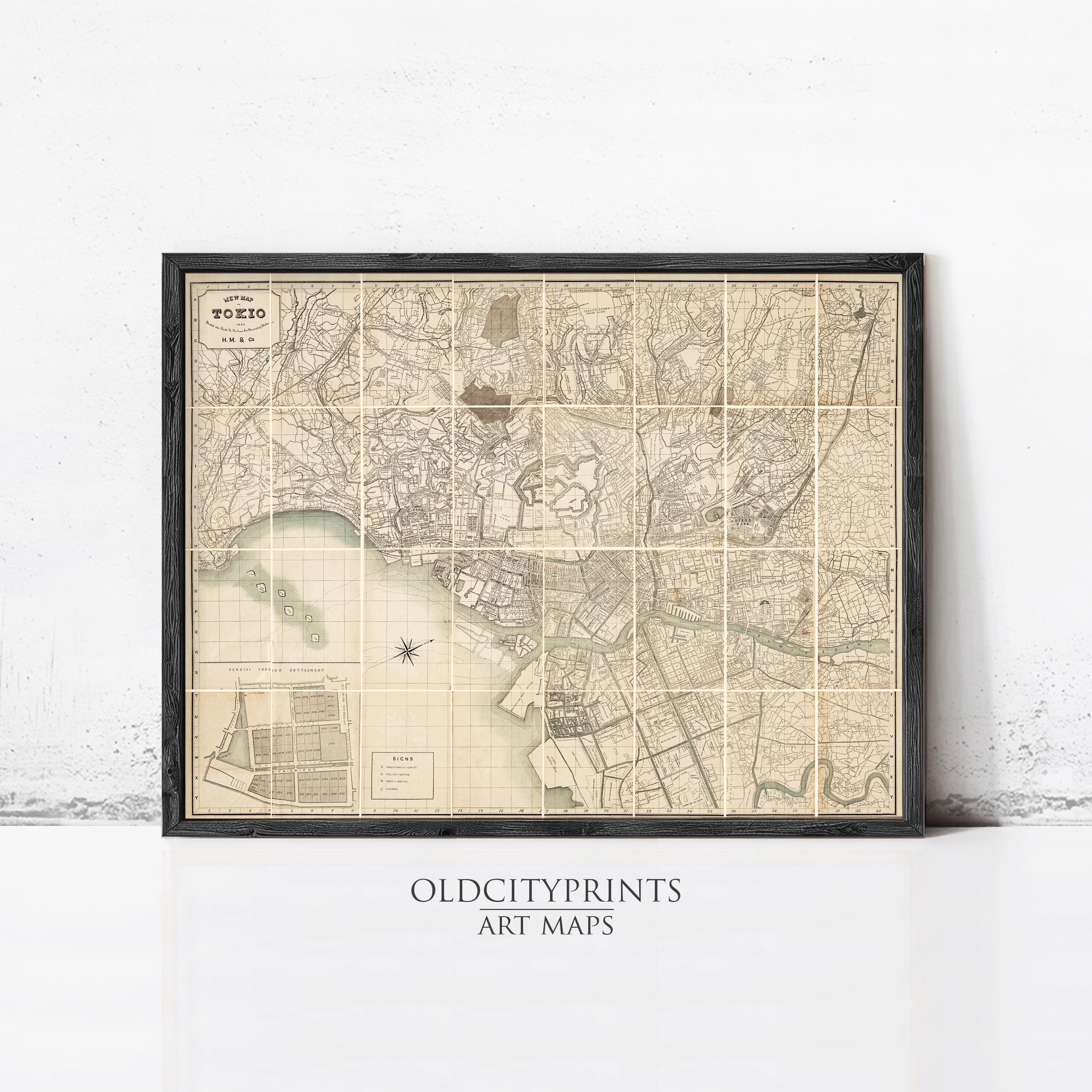 The image is a framed vintage map of a city, likely Tokyo, with detailed cartography and a grid-like layout.
