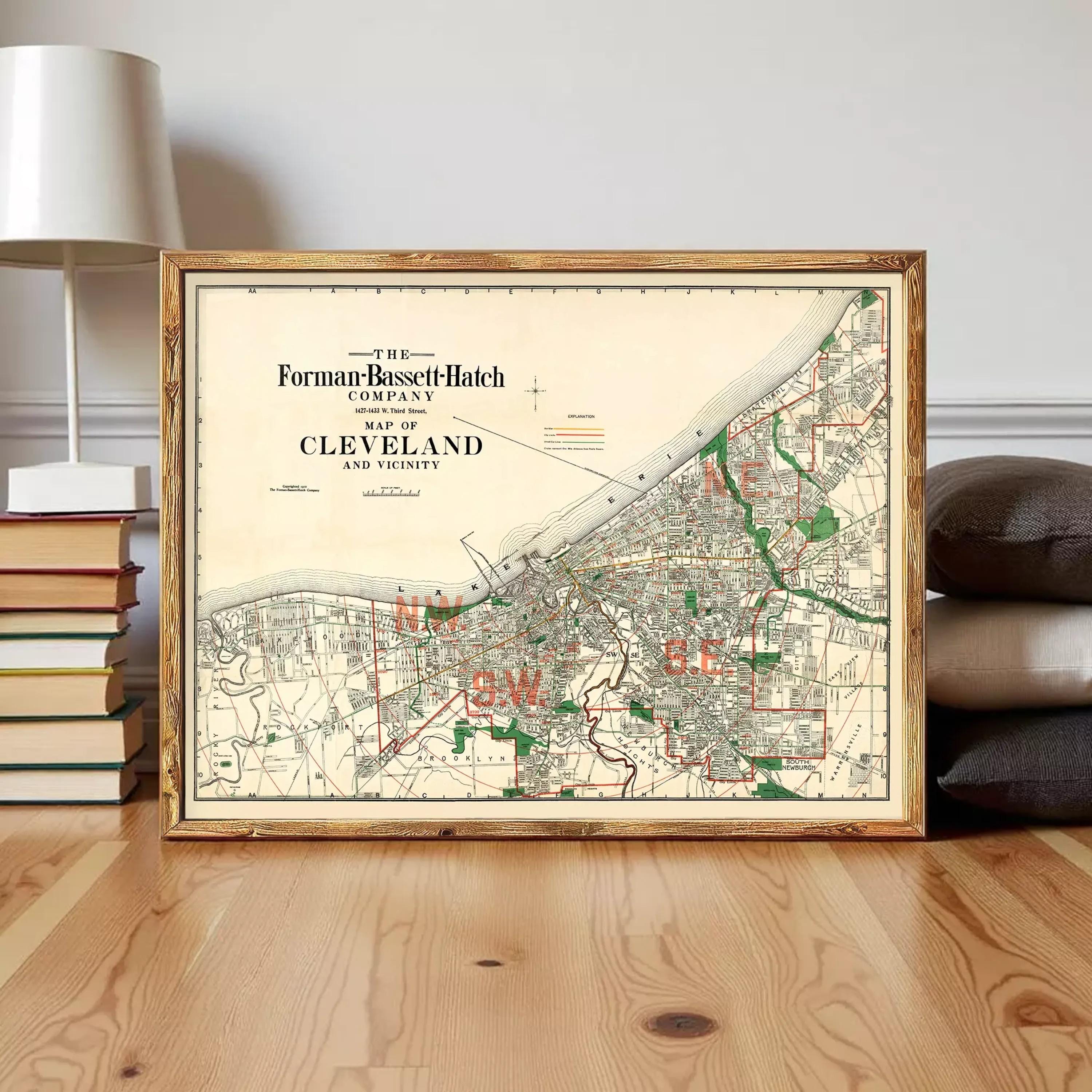 The image is a framed vintage map of Cleveland, Ohio, depicting the city's streets and surrounding areas.