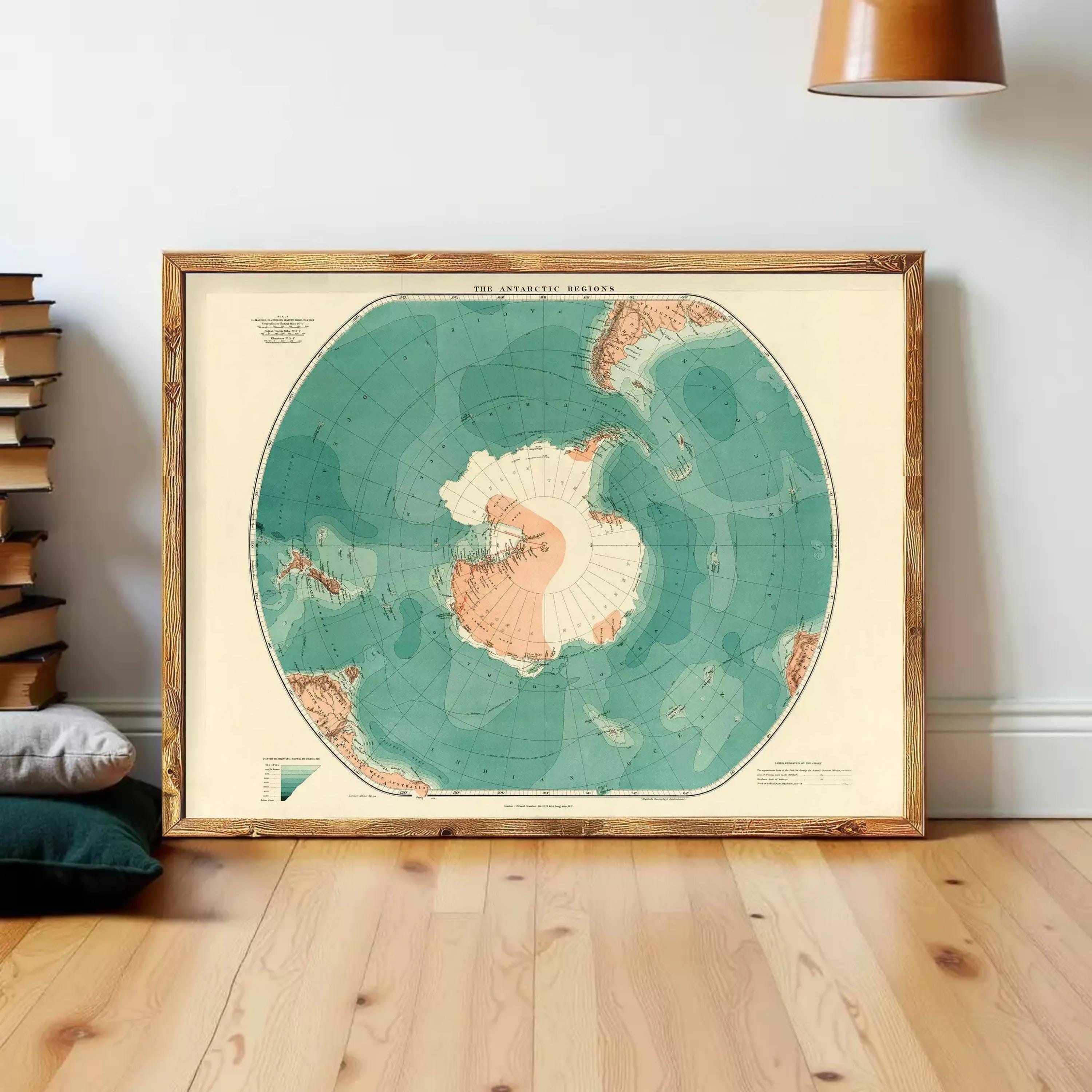 A framed map of the Arctic regions is displayed on a wooden floor against a white wall.