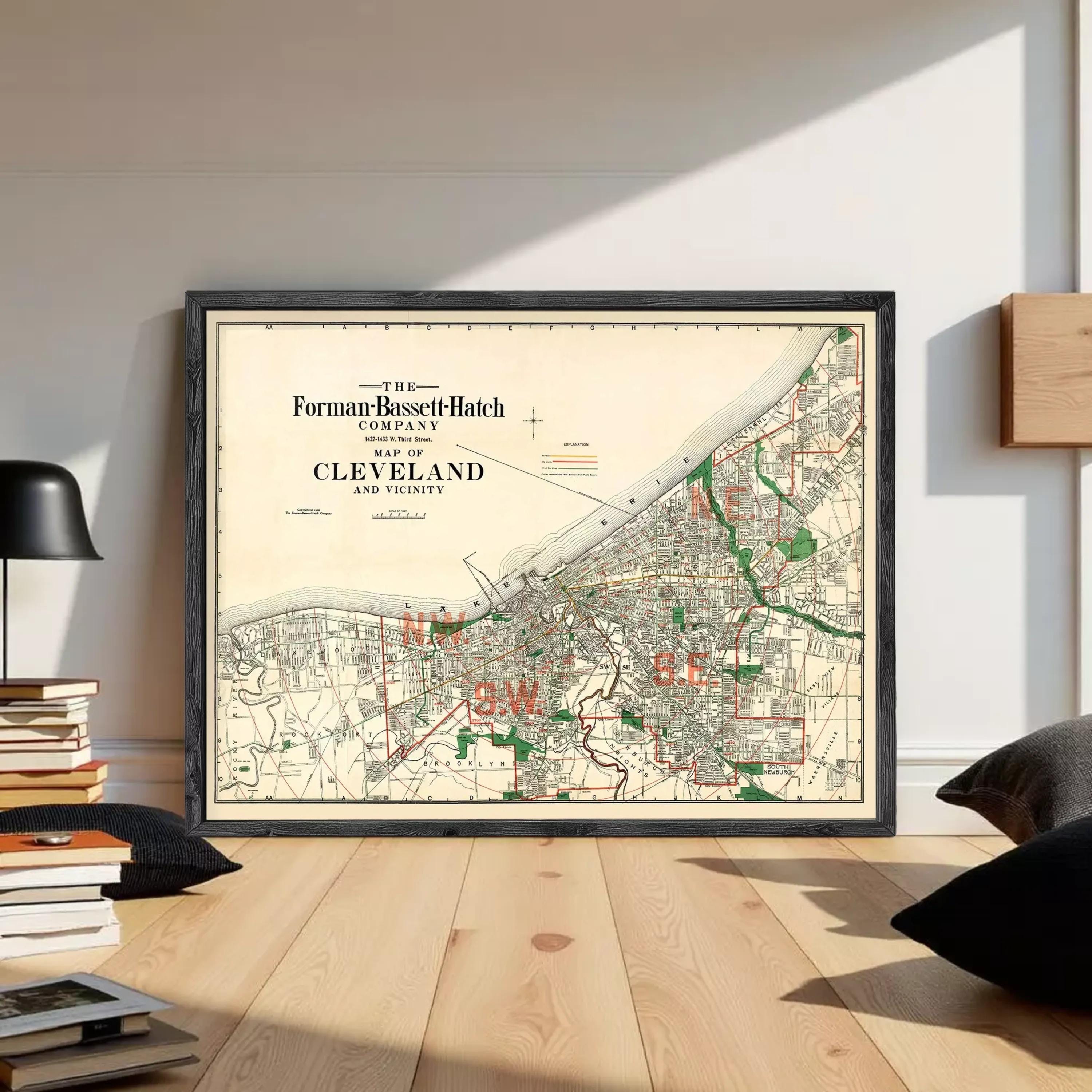 The image is a framed vintage map of Cleveland, Ohio, depicting the city's streets and surrounding areas.