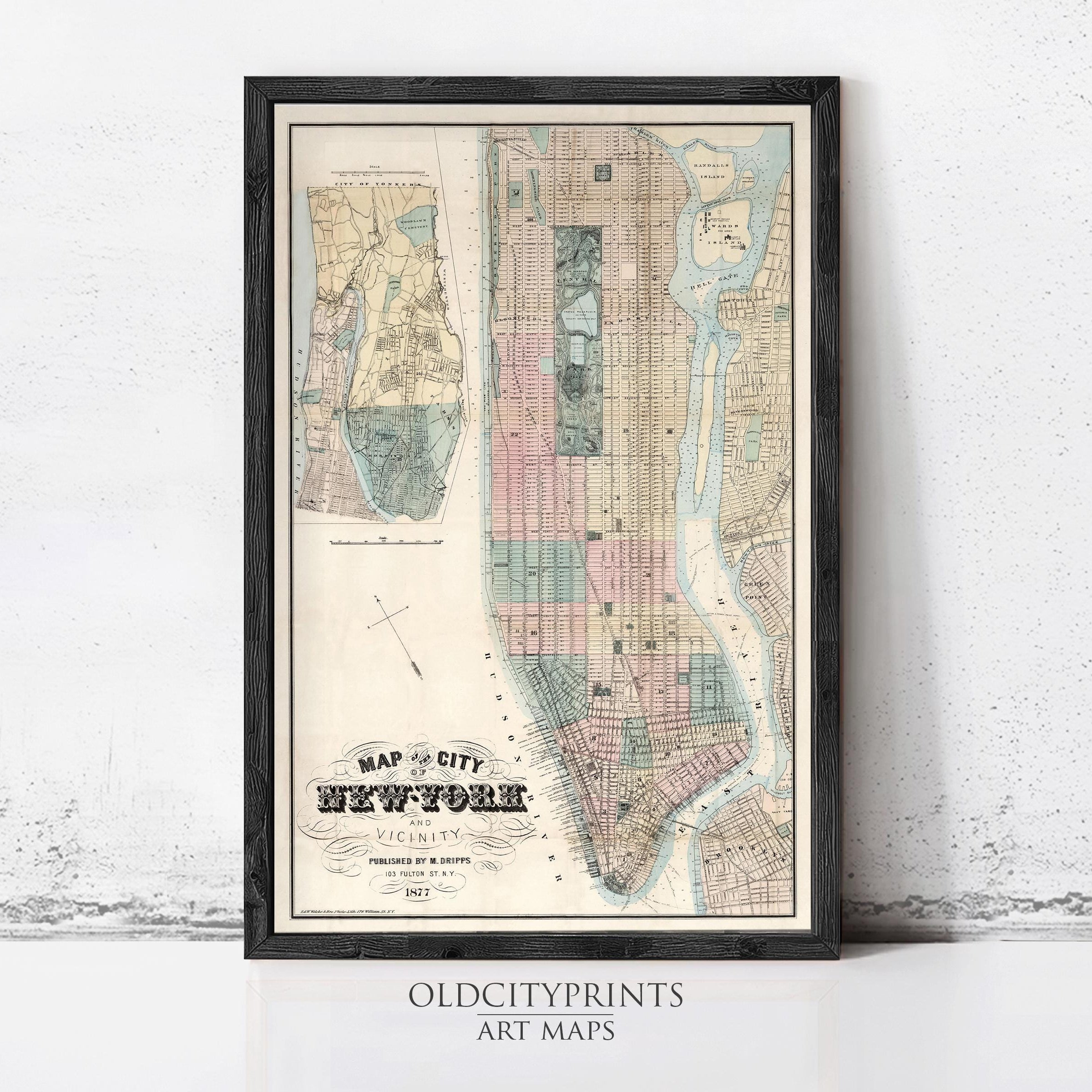 The image is a framed vintage map of New York City, depicting the city's streets and neighborhoods in a detailed and colorful manner.