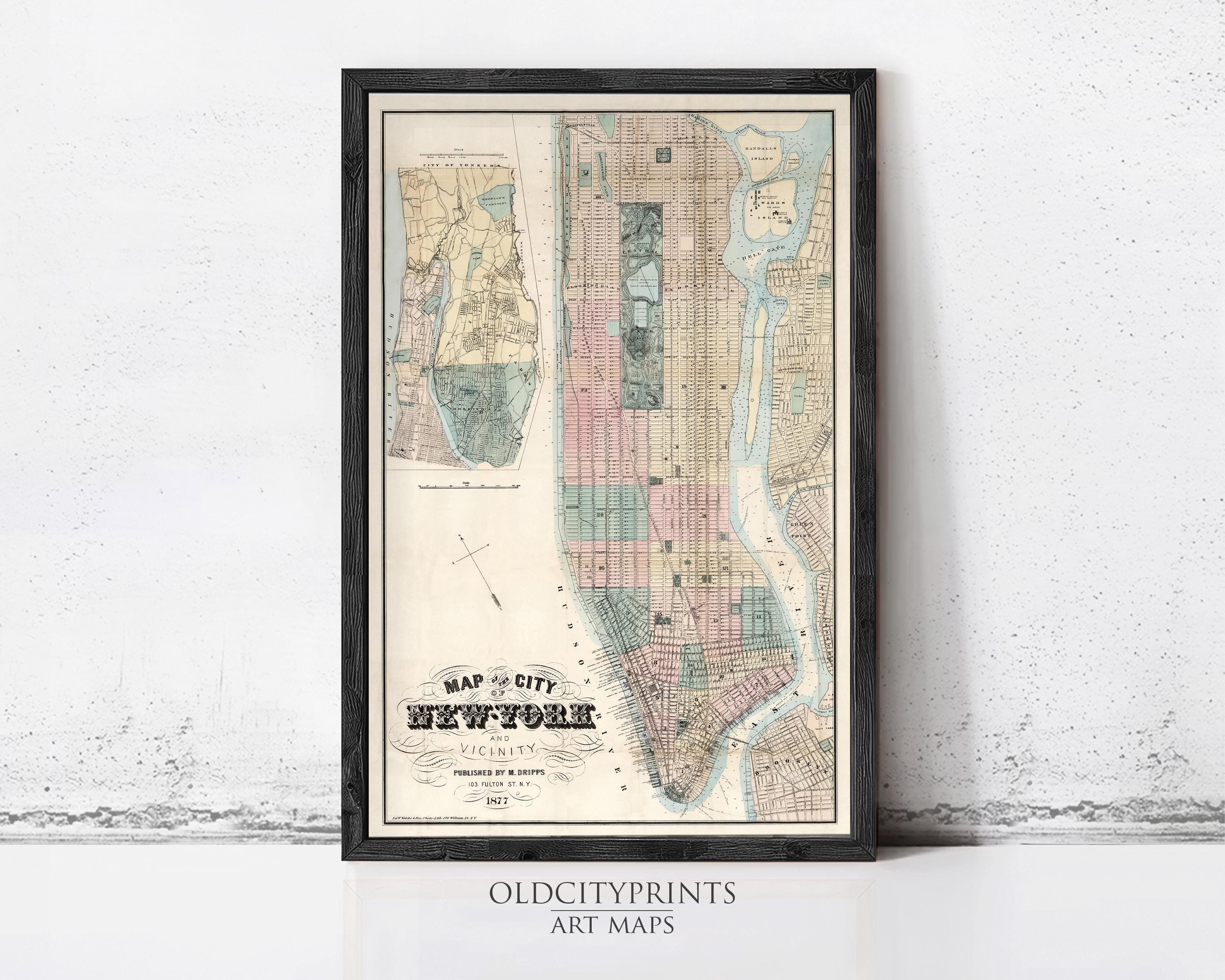 The image is a framed vintage map of New York City, depicting the city's streets and neighborhoods in a detailed and colorful manner.