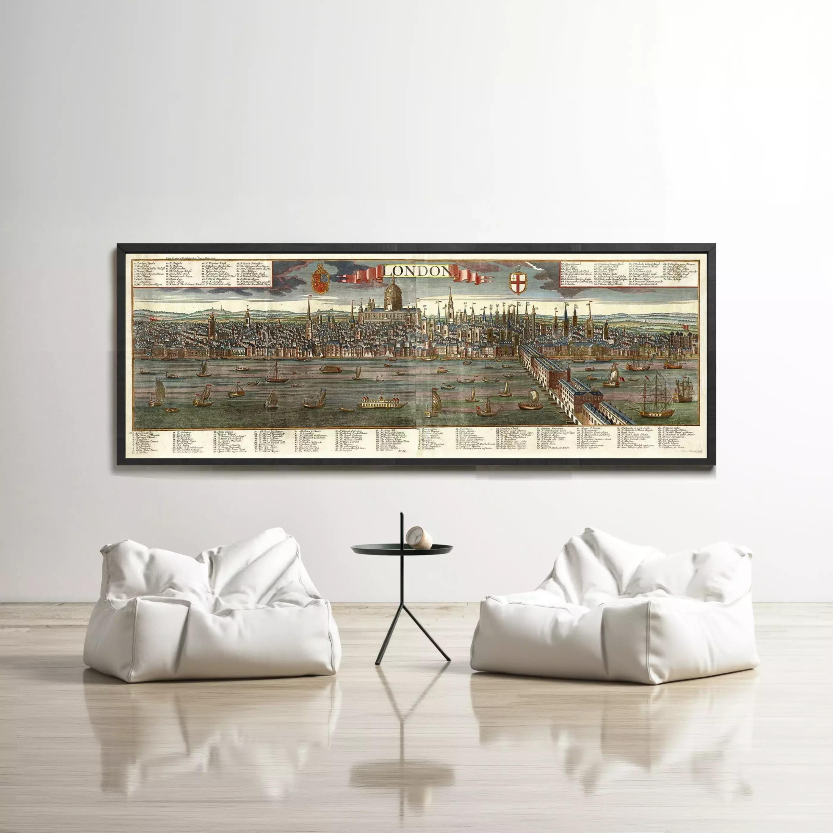 a large framed map of London hanging on a white wall, with two white bean bag chairs positioned in front of it.