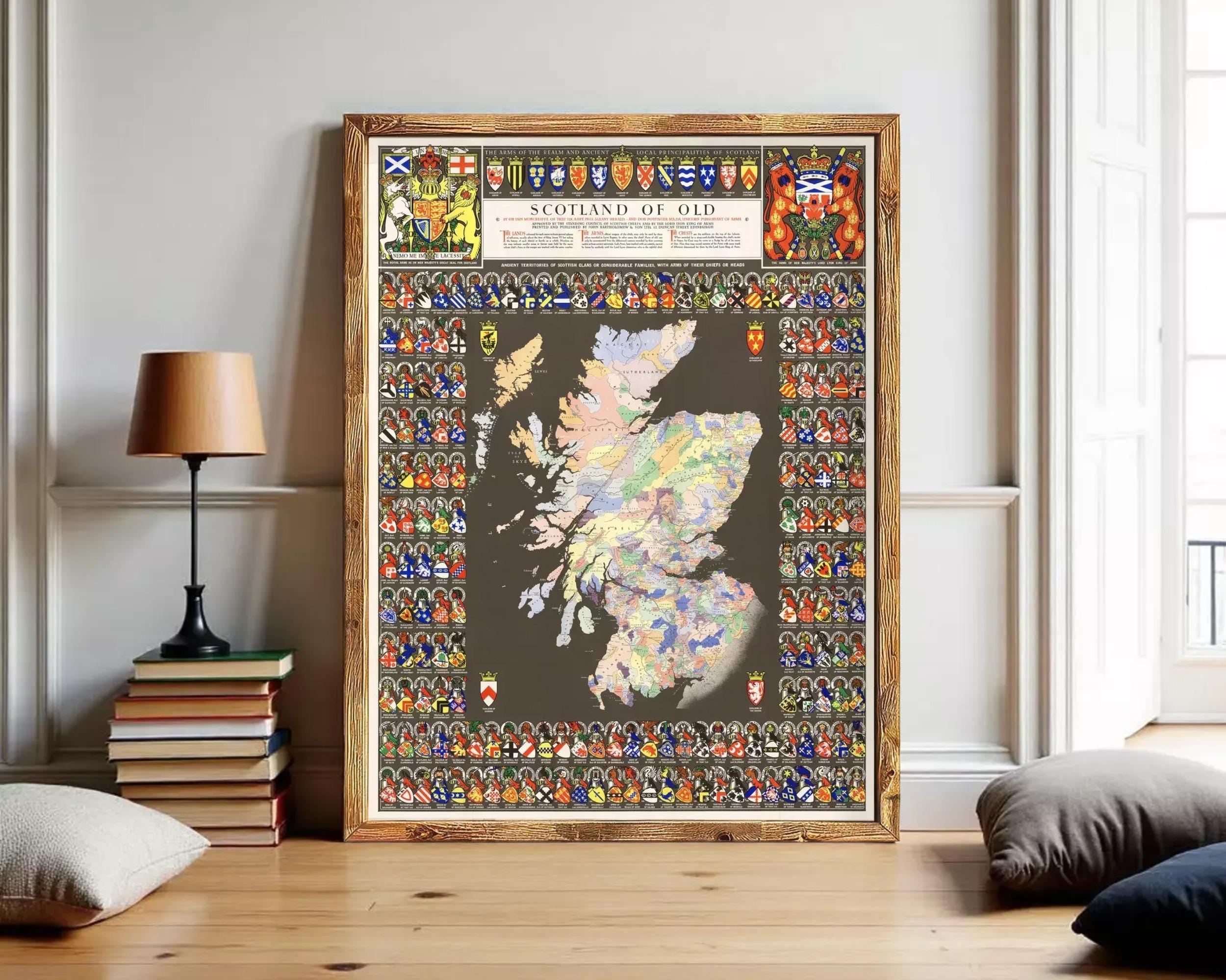 The image is a framed map of Scotland, featuring a variety of symbols and coat of arms representing different regions and groups within the country.