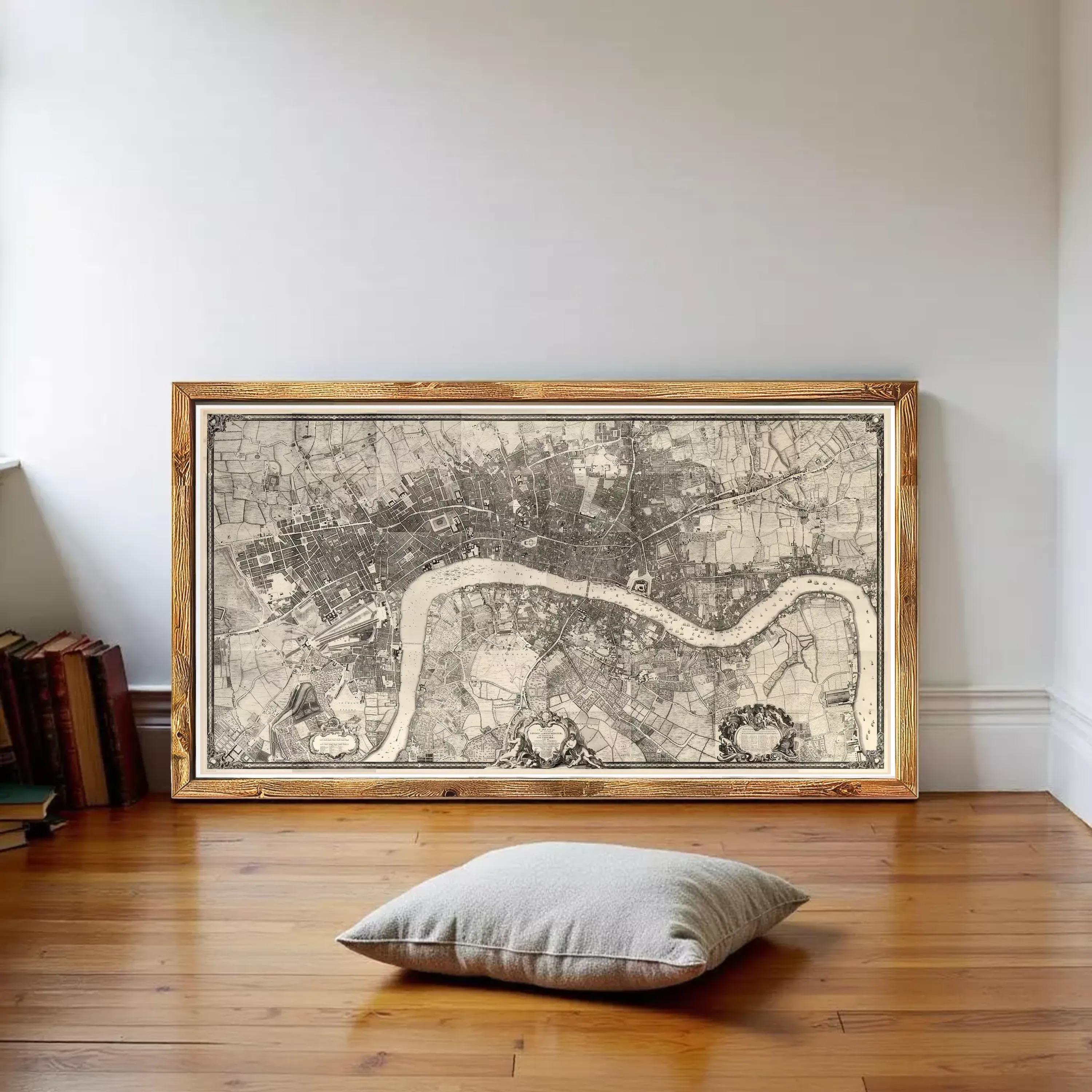 a large framed map of London, with a wooden floor and a pillow in the foreground.