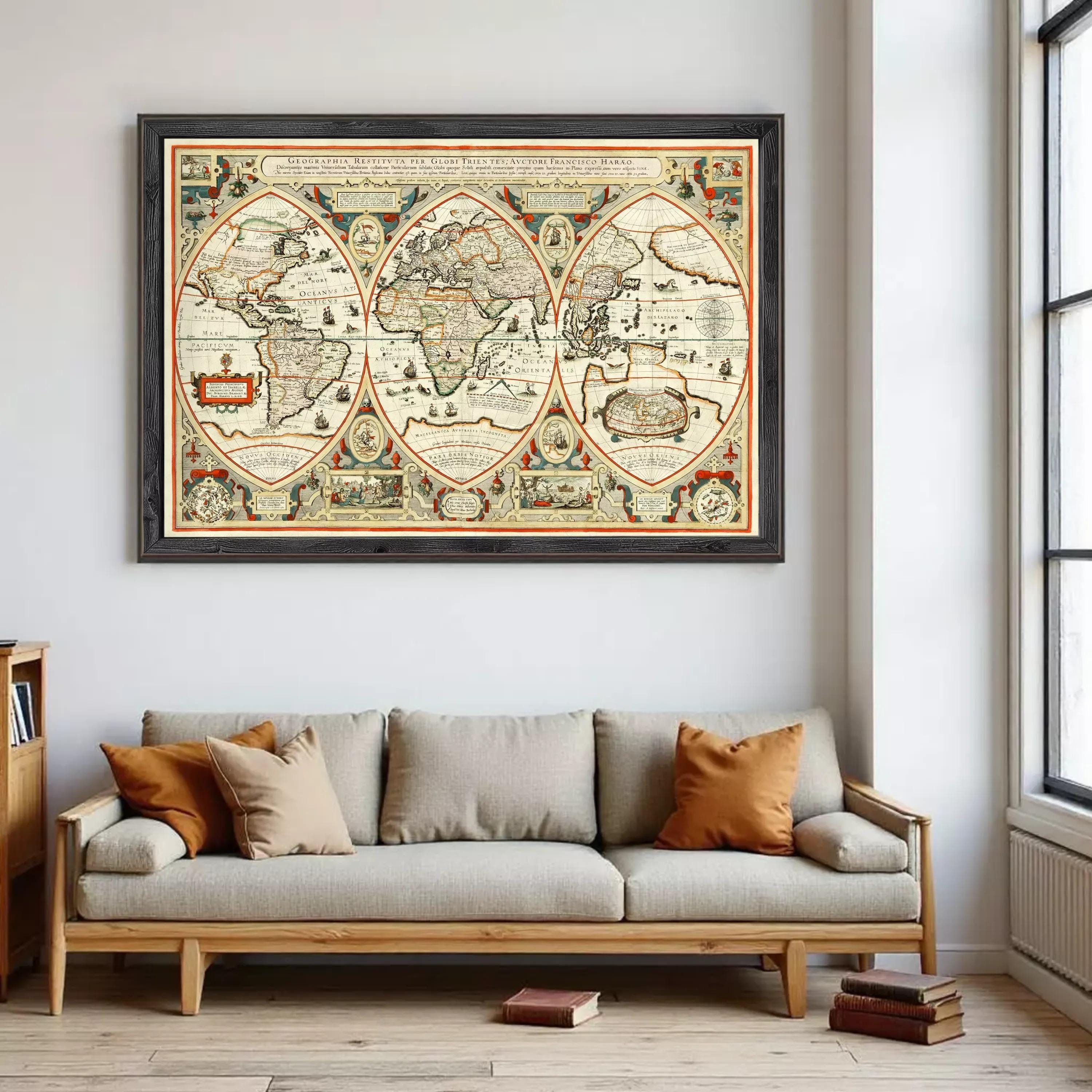 a large, ornate world map hanging on a wall above a gray sofa with orange throw pillows.