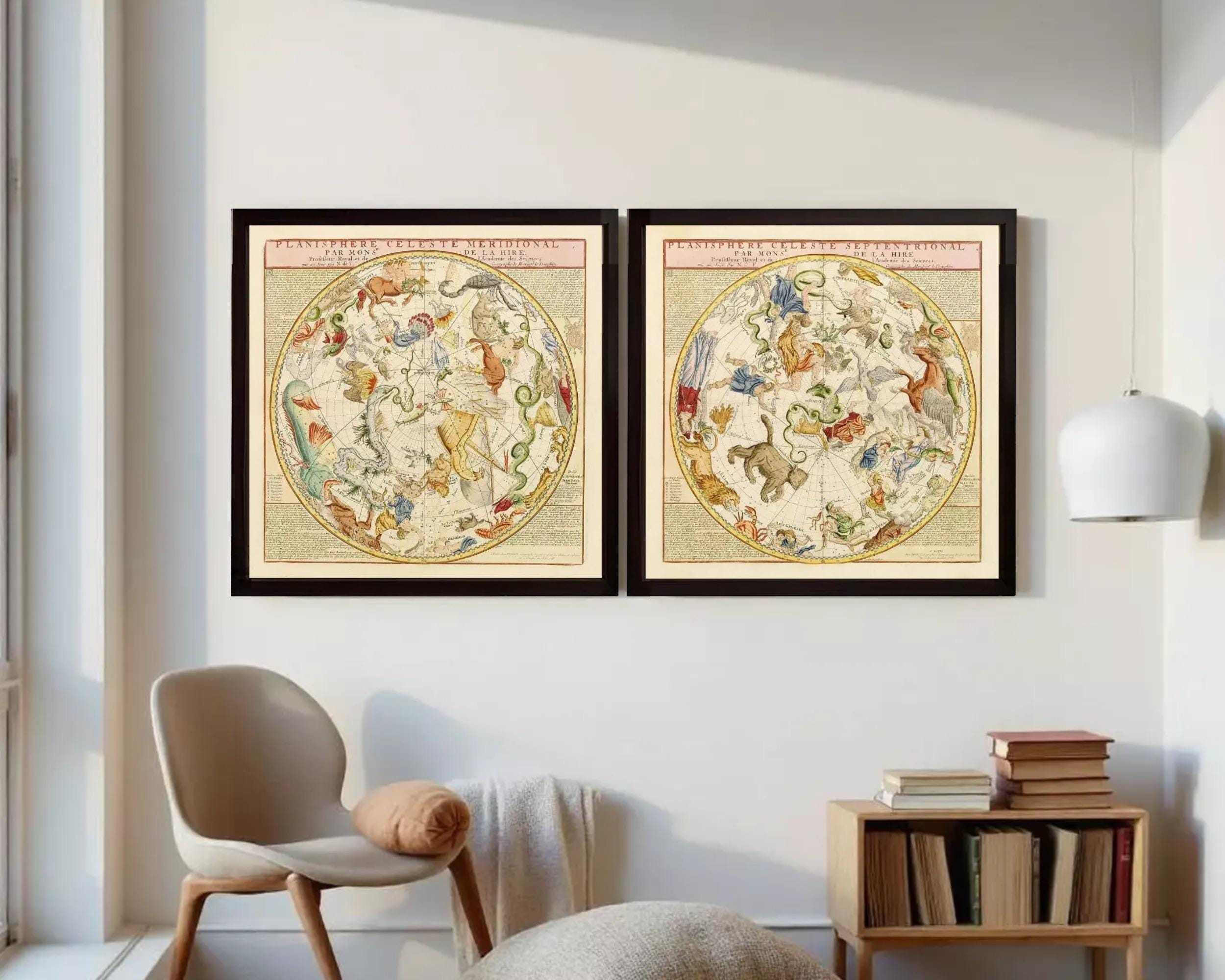 two framed celestial maps of the night sky, displayed against a white wall.