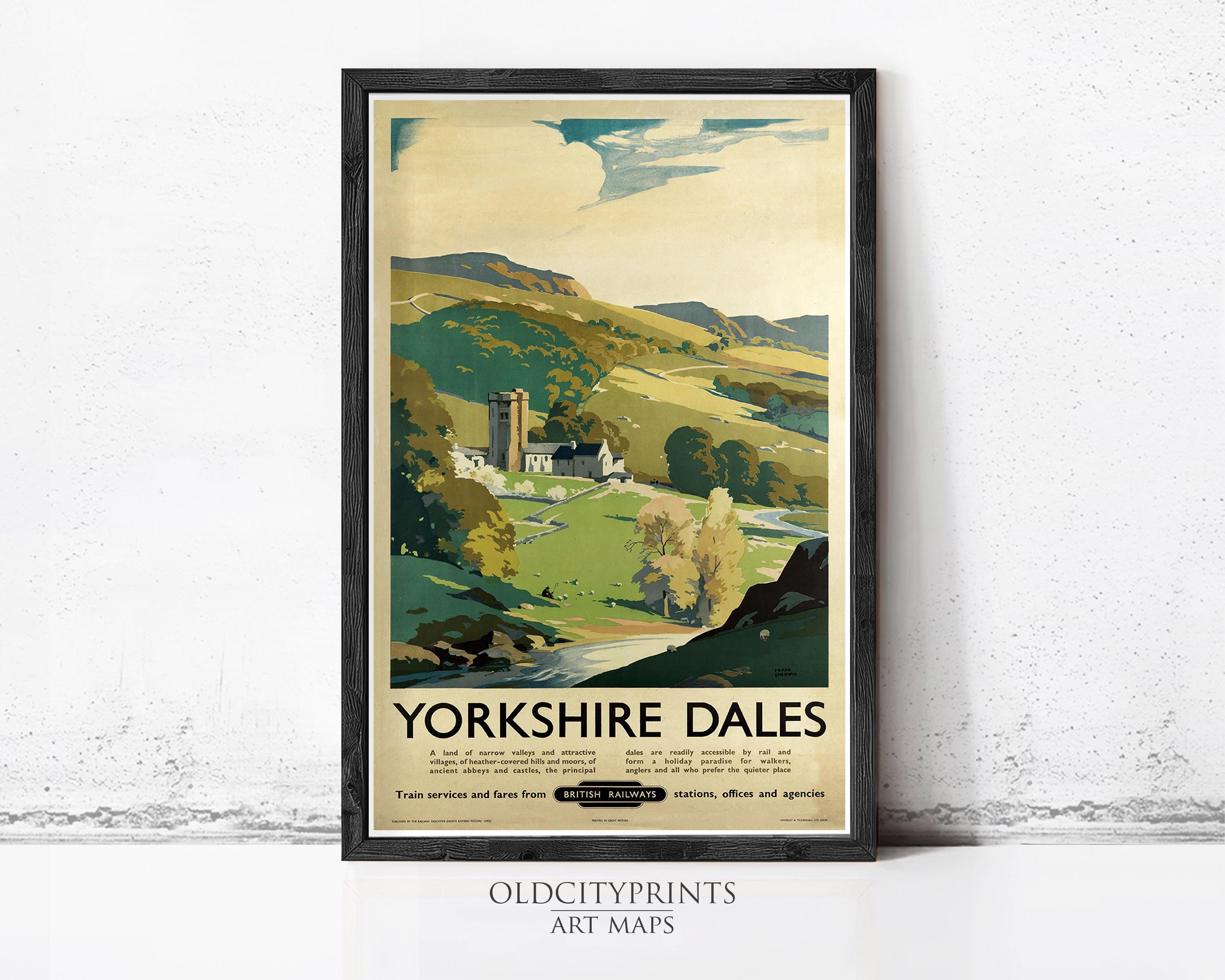 A framed vintage travel poster advertising Yorkshire Dales, featuring a scenic countryside landscape with a church, river, and rolling hills.