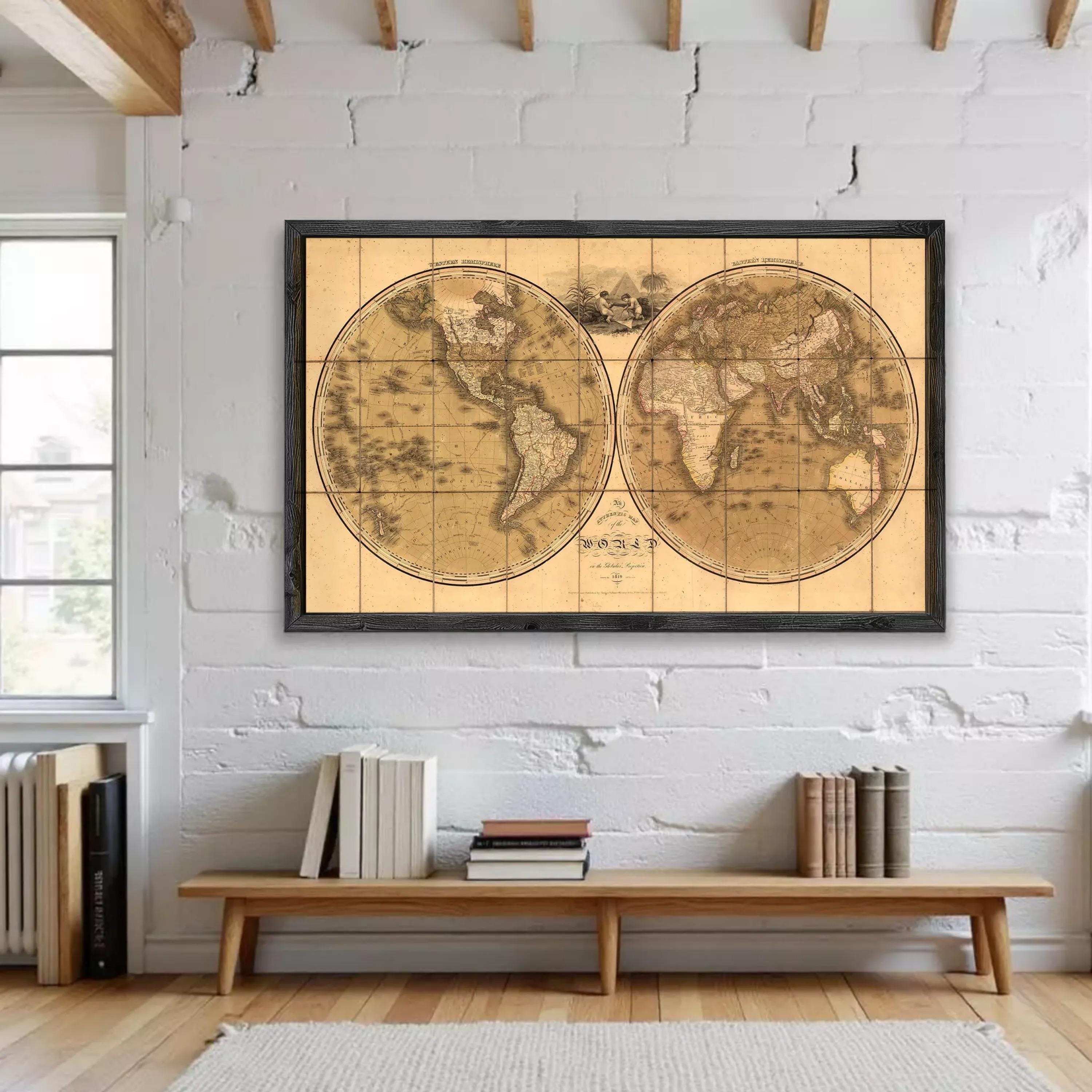 a large, antique world map hanging on a white wall in a room with a wooden bench and a bookshelf below it.
