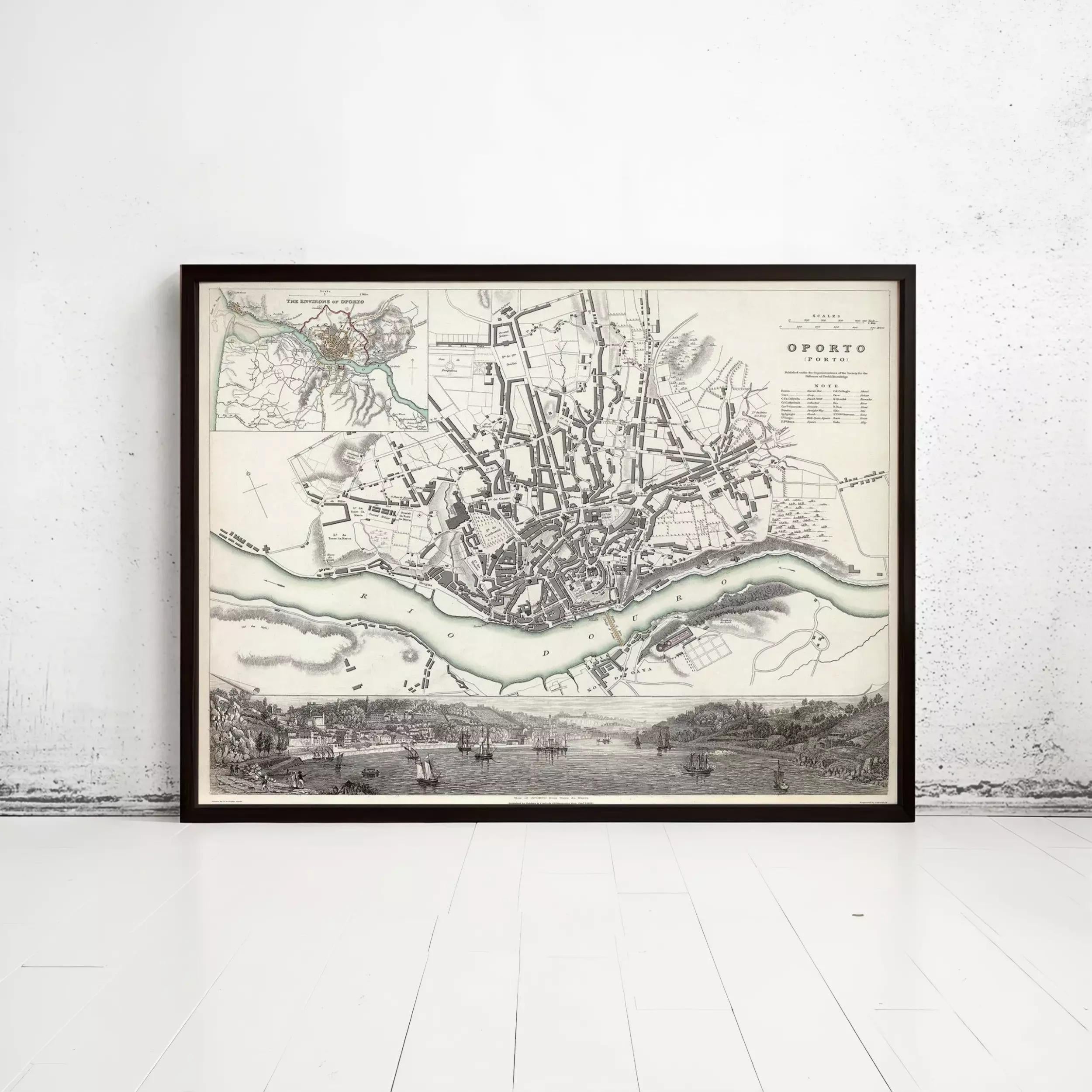 The image is a framed historical map of a city, depicting a detailed layout of the streets, rivers, and surrounding landscape.