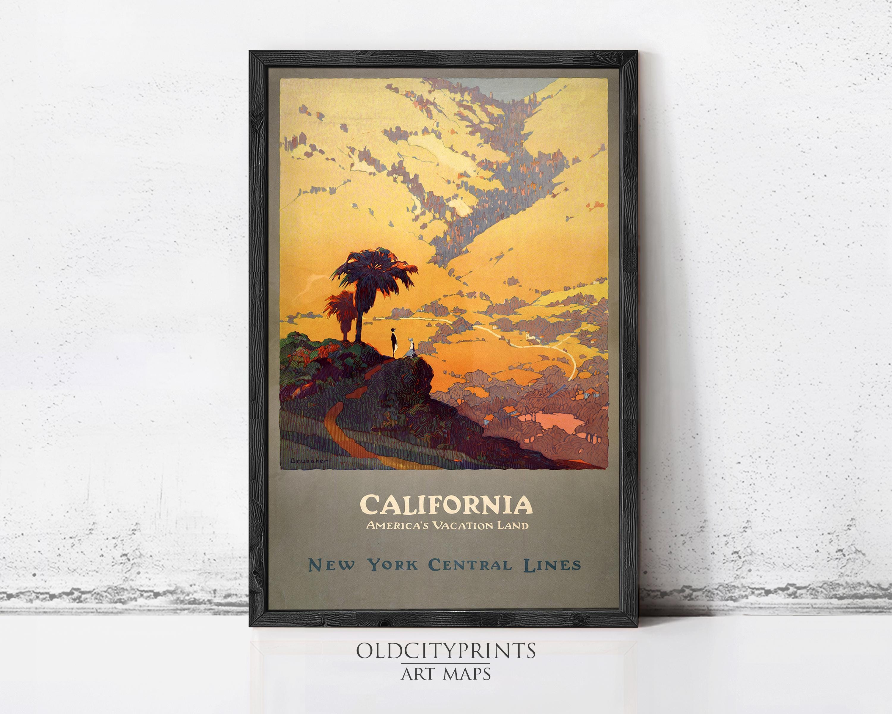 A framed vintage travel poster depicting a scenic landscape with a palm tree and a sunset over the ocean, advertising California as a vacation land.