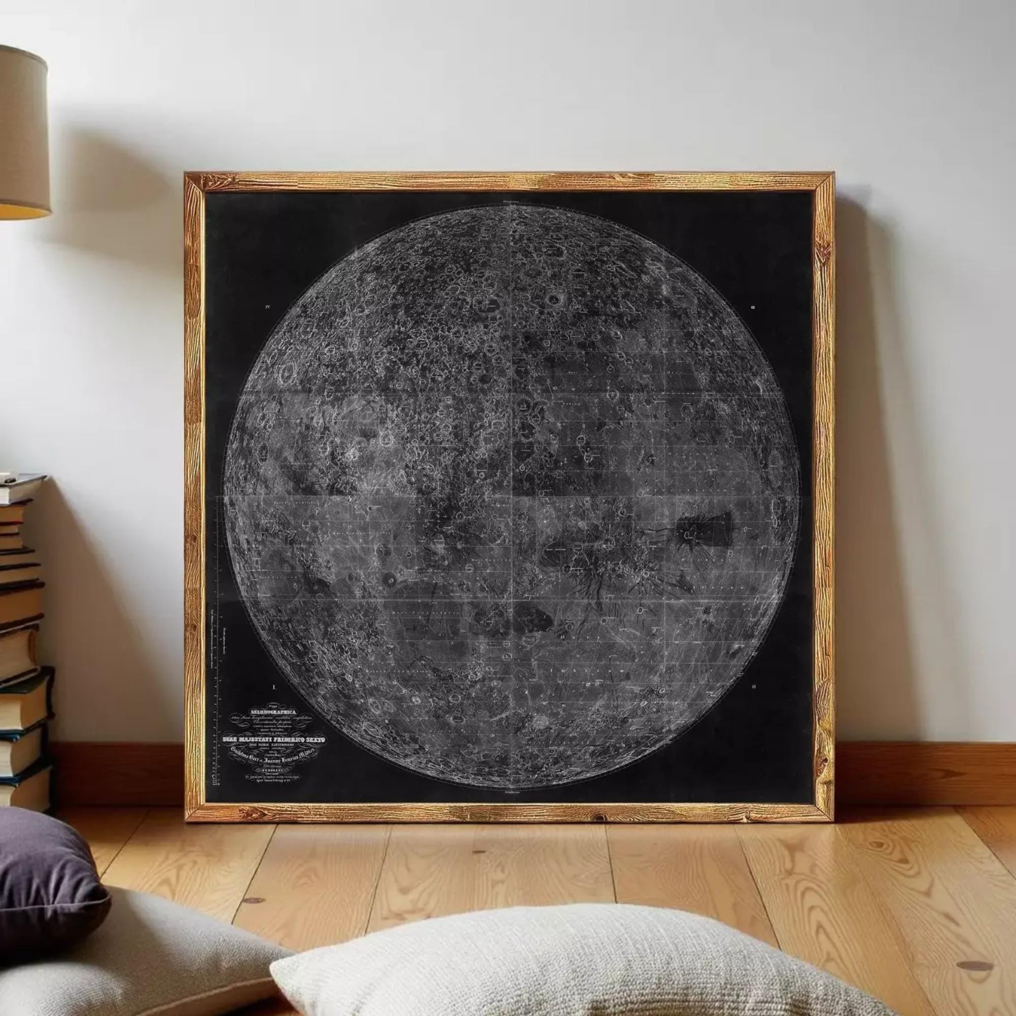 a large, detailed black and white map of the moon, displayed in a wooden frame on a wooden floor.