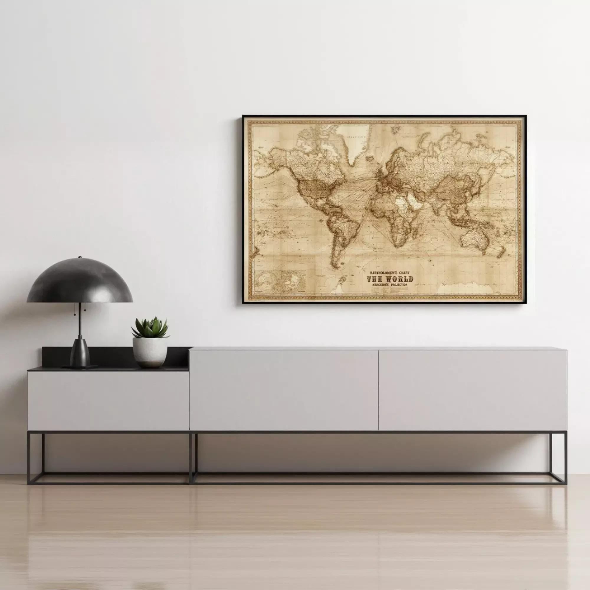 a large world map poster hanging on a wall above a gray cabinet or console.