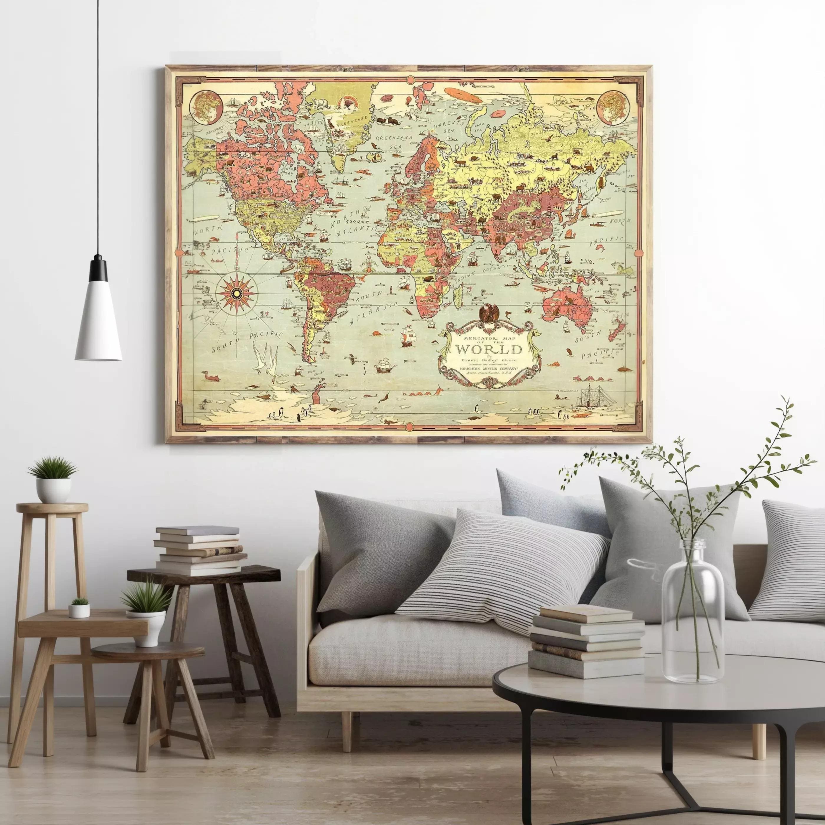 a large world map hanging on a wall in a living room, with a couch, coffee table, and other decor elements in the background.