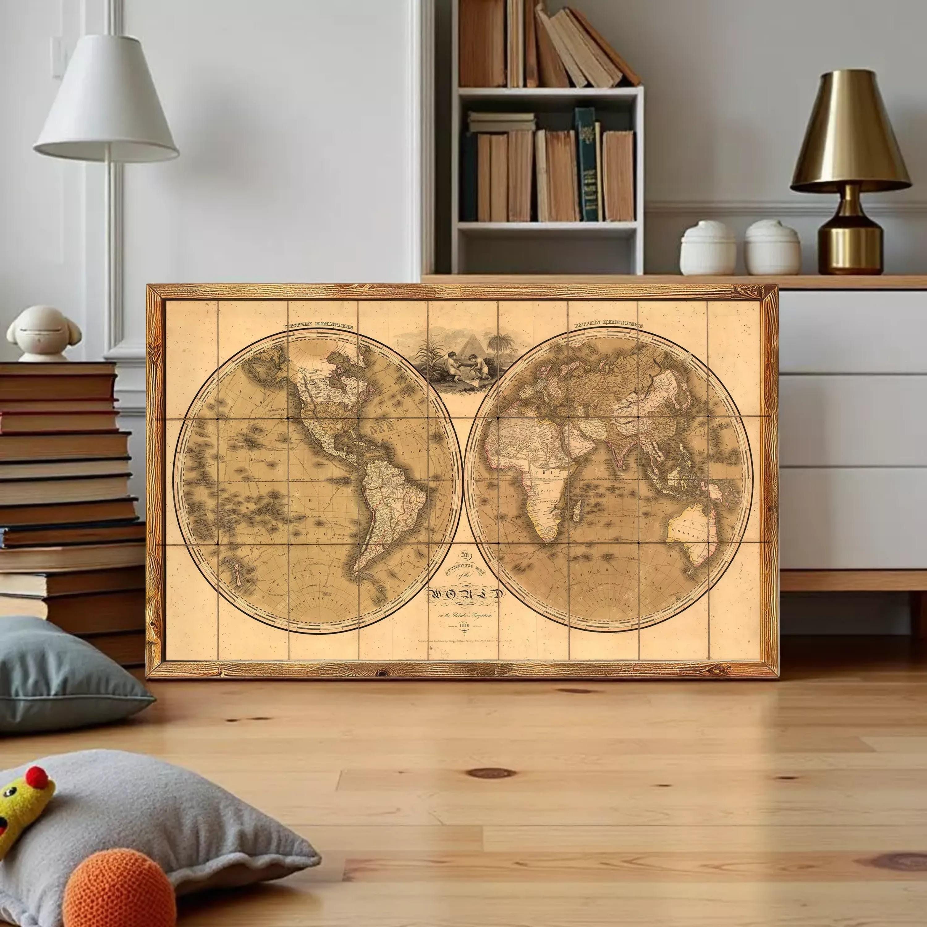 a large, antique-style world map displayed on a wooden frame, placed on a wooden floor in a room with bookshelves and lamps.