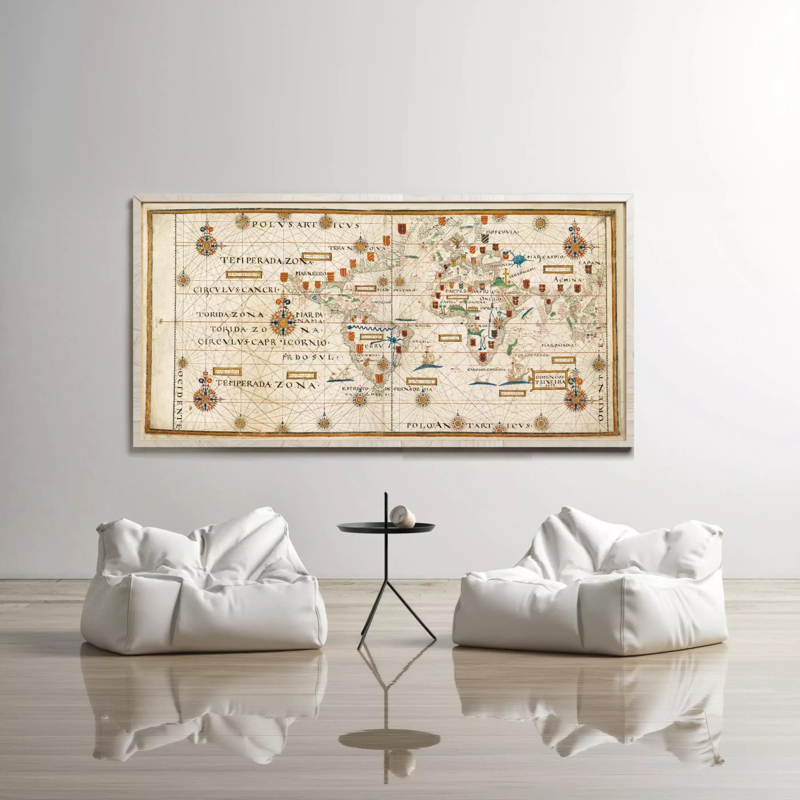 a large world map hanging on a white wall, with two white bean bag chairs positioned in front of it.