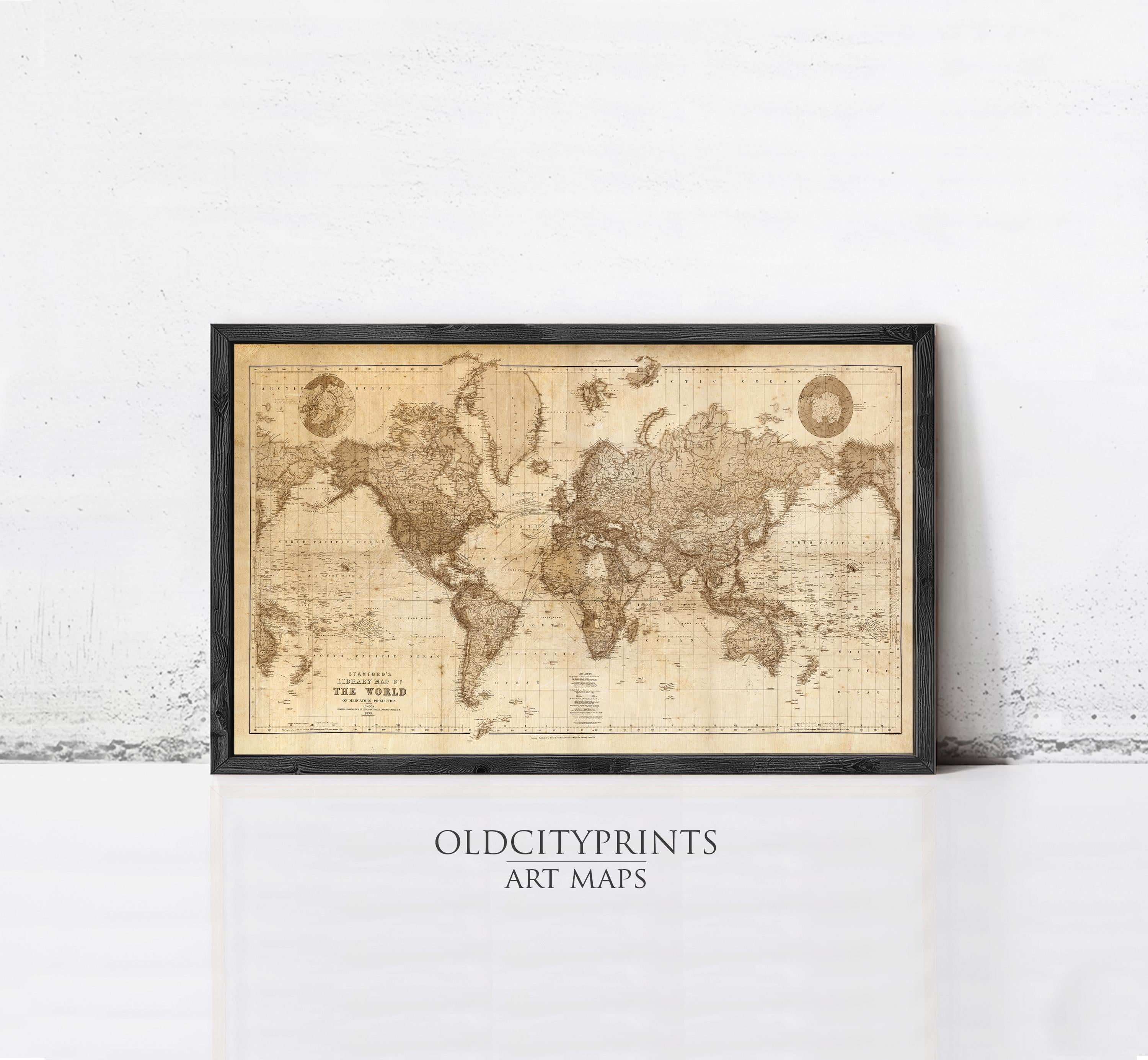 A framed vintage world map with the text "The World" printed on it, displayed on a white wall.