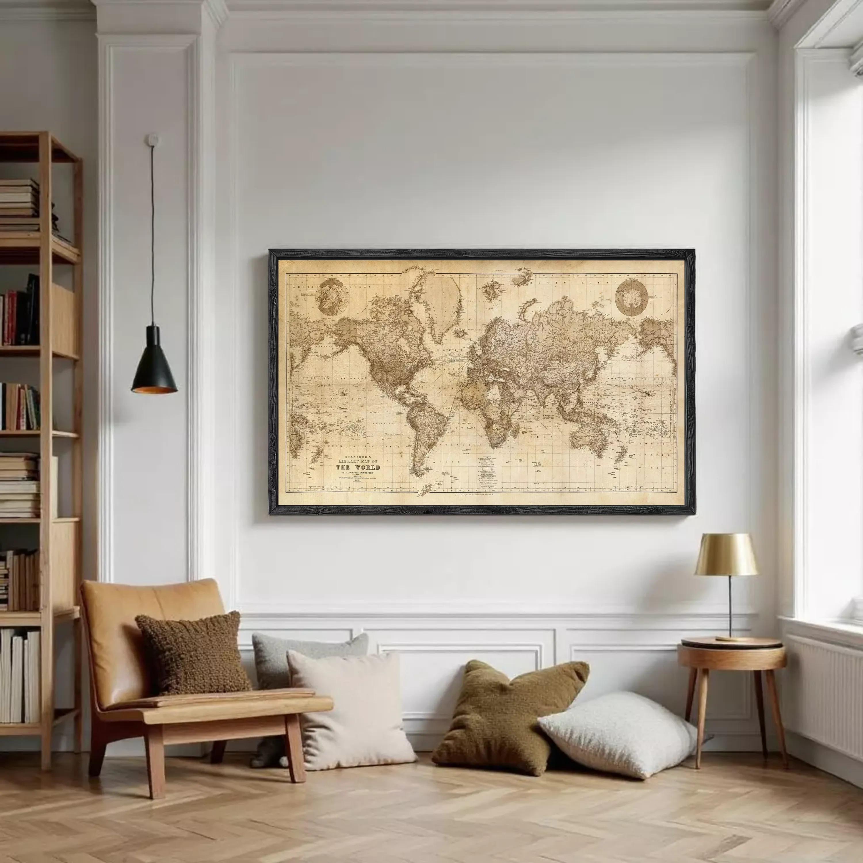 The image is a framed vintage world map with a black border, displayed on a white wall.