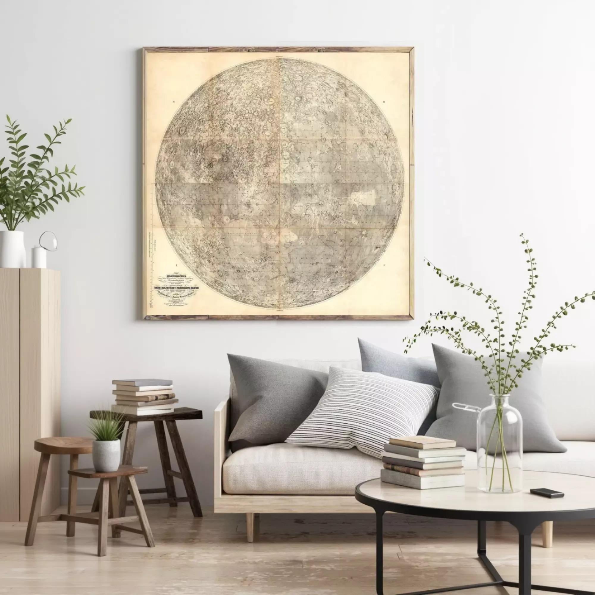 a living room with a large, vintage-style map of the moon hanging on the wall above a gray sofa. The room is decorated with a wooden coffee table, a potted plant, and a stack of books.