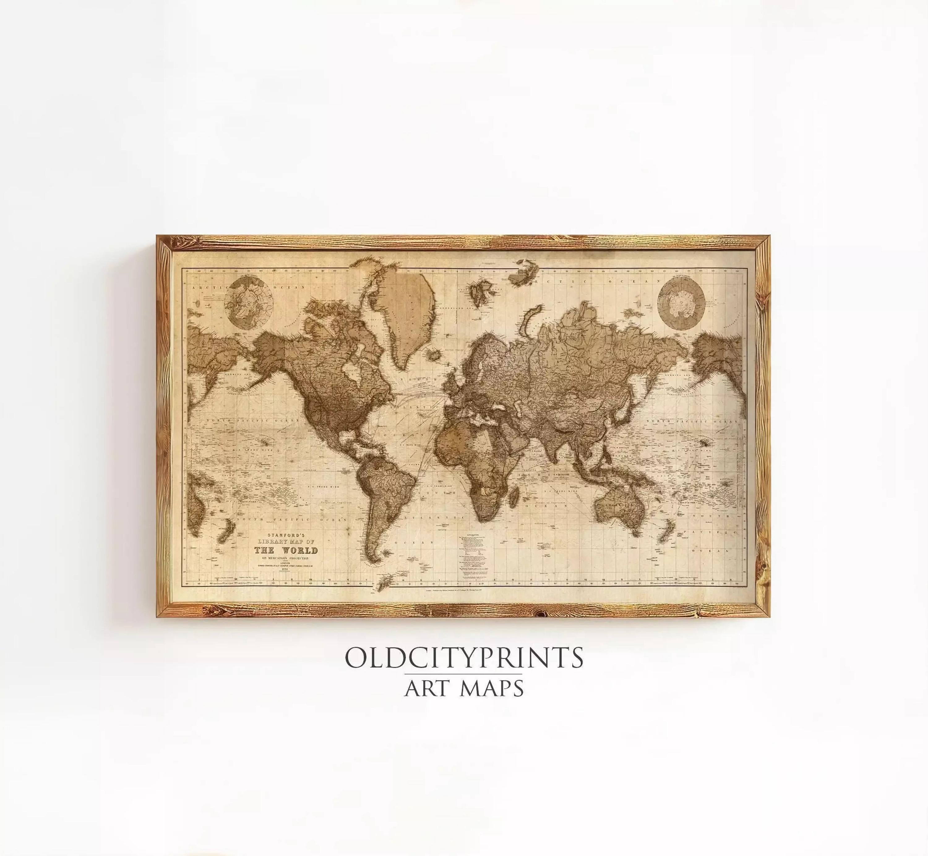 The image is a framed vintage world map with a wooden border, displayed on a white wall.