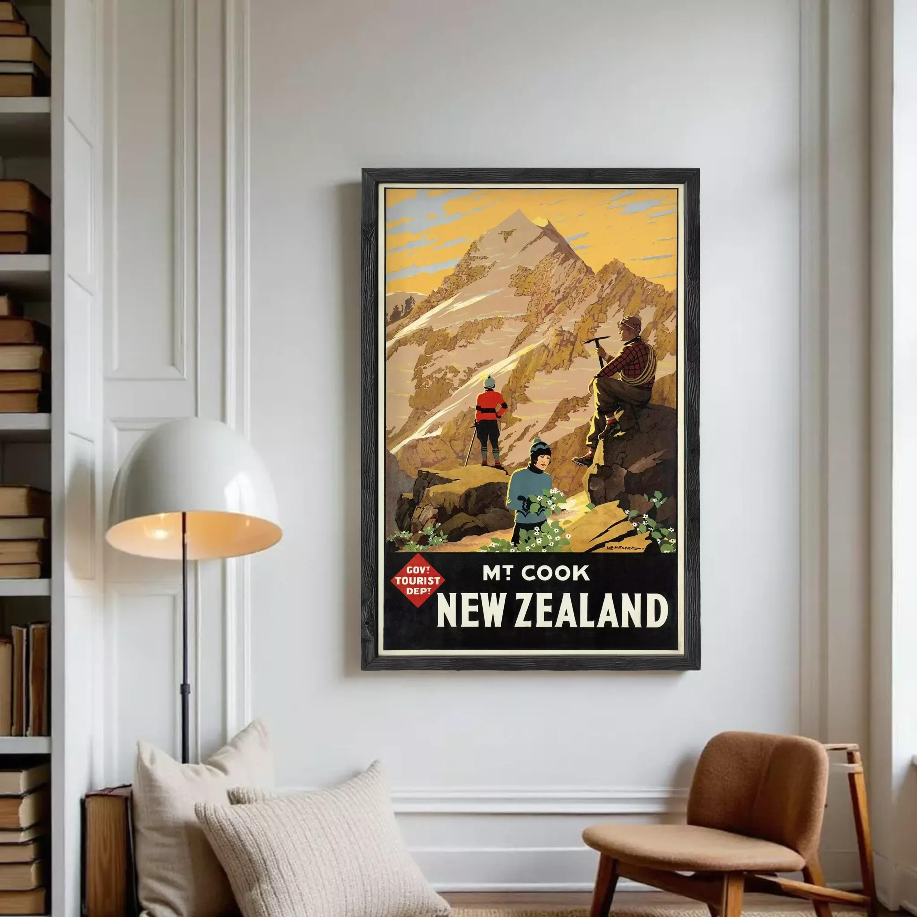 A framed vintage travel poster depicting a mountain landscape with people hiking, set against a yellow sky with clouds.