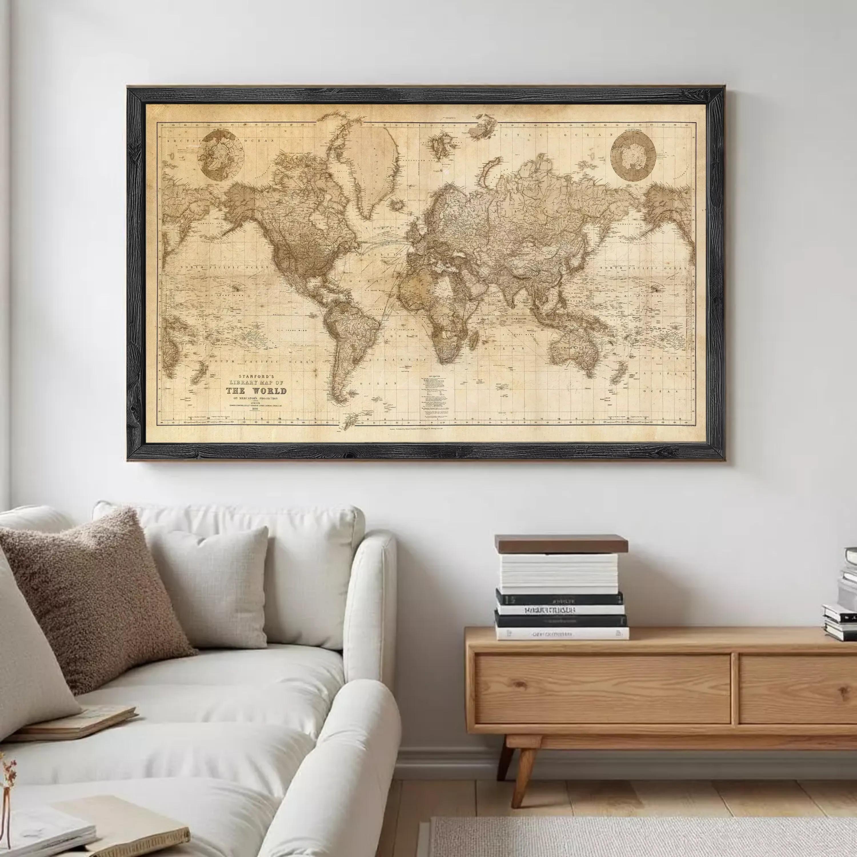 a large world map hanging on a wall above a couch in a living room setting.