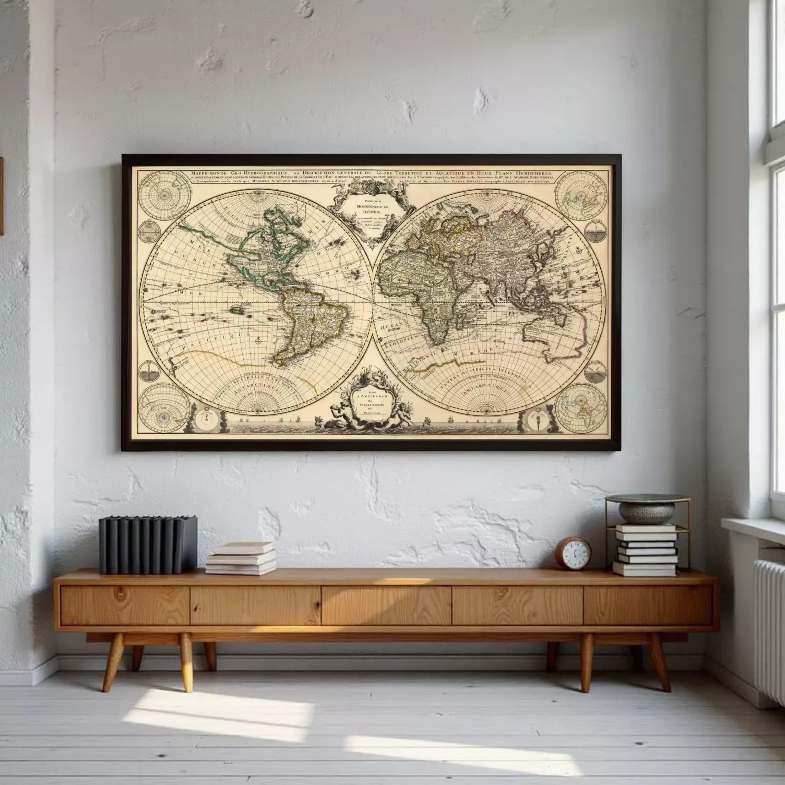 A large antique world map is displayed on the wall above a wooden entertainment center in a room with white walls.