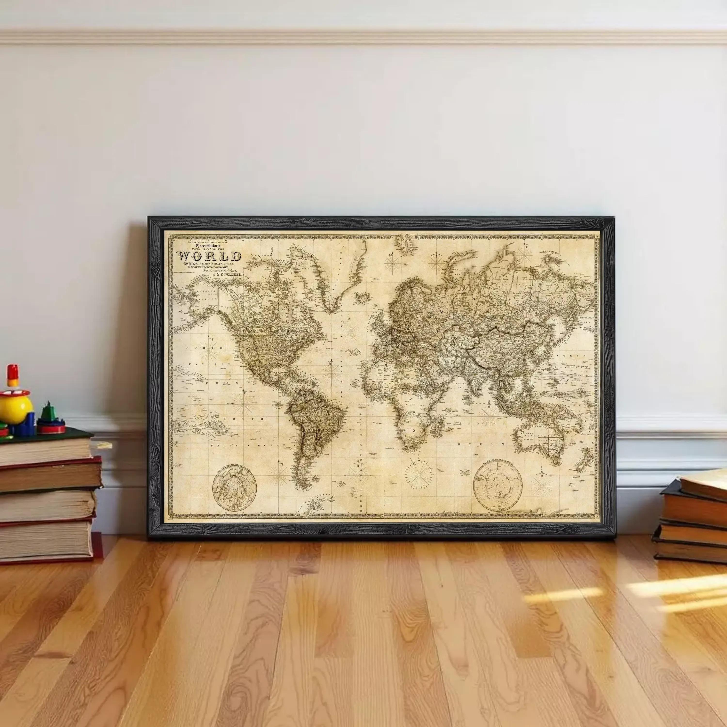 A large world map in a black frame is displayed on a wooden floor against a white wall.