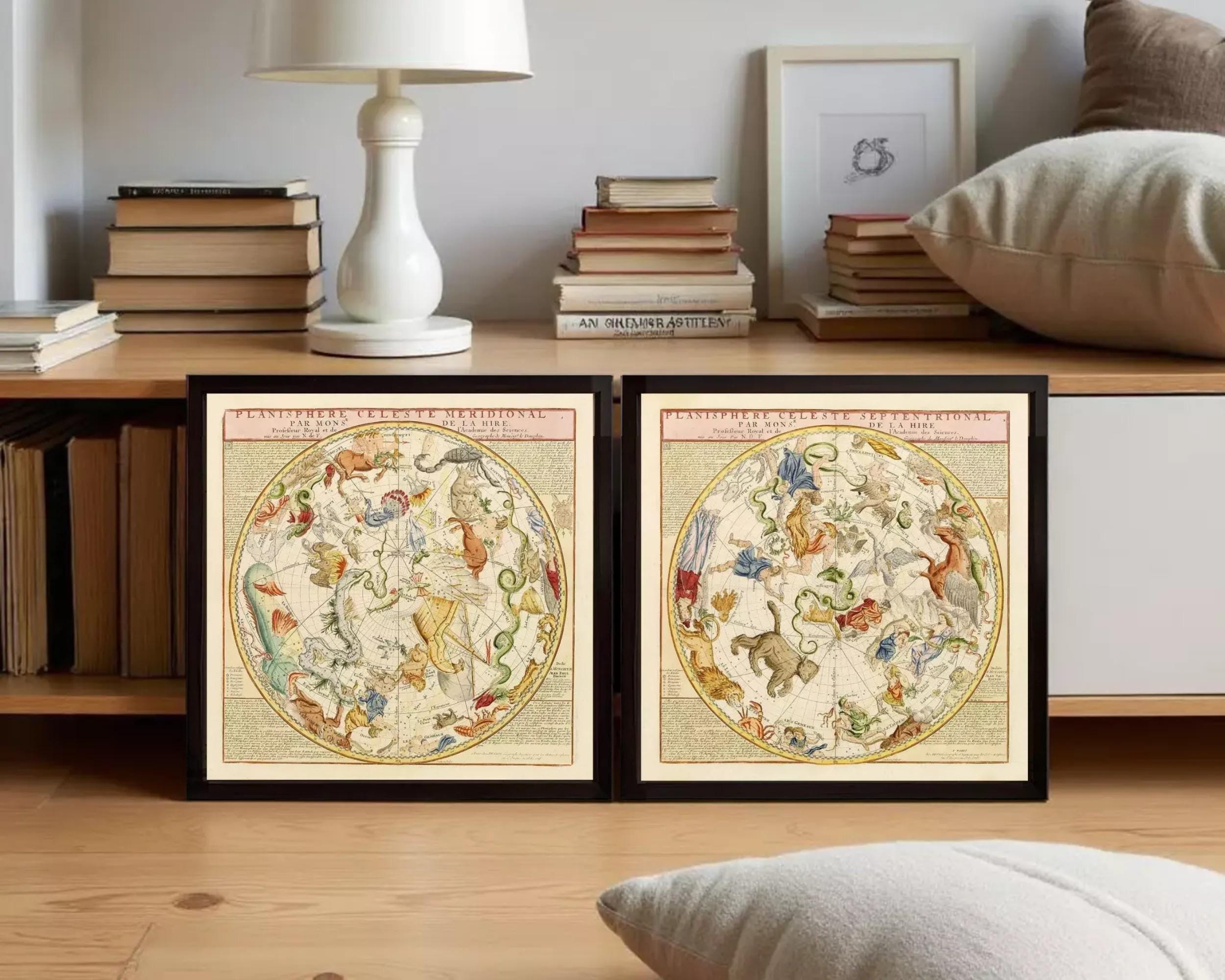 two framed celestial maps of the night sky, displayed against a white wall.