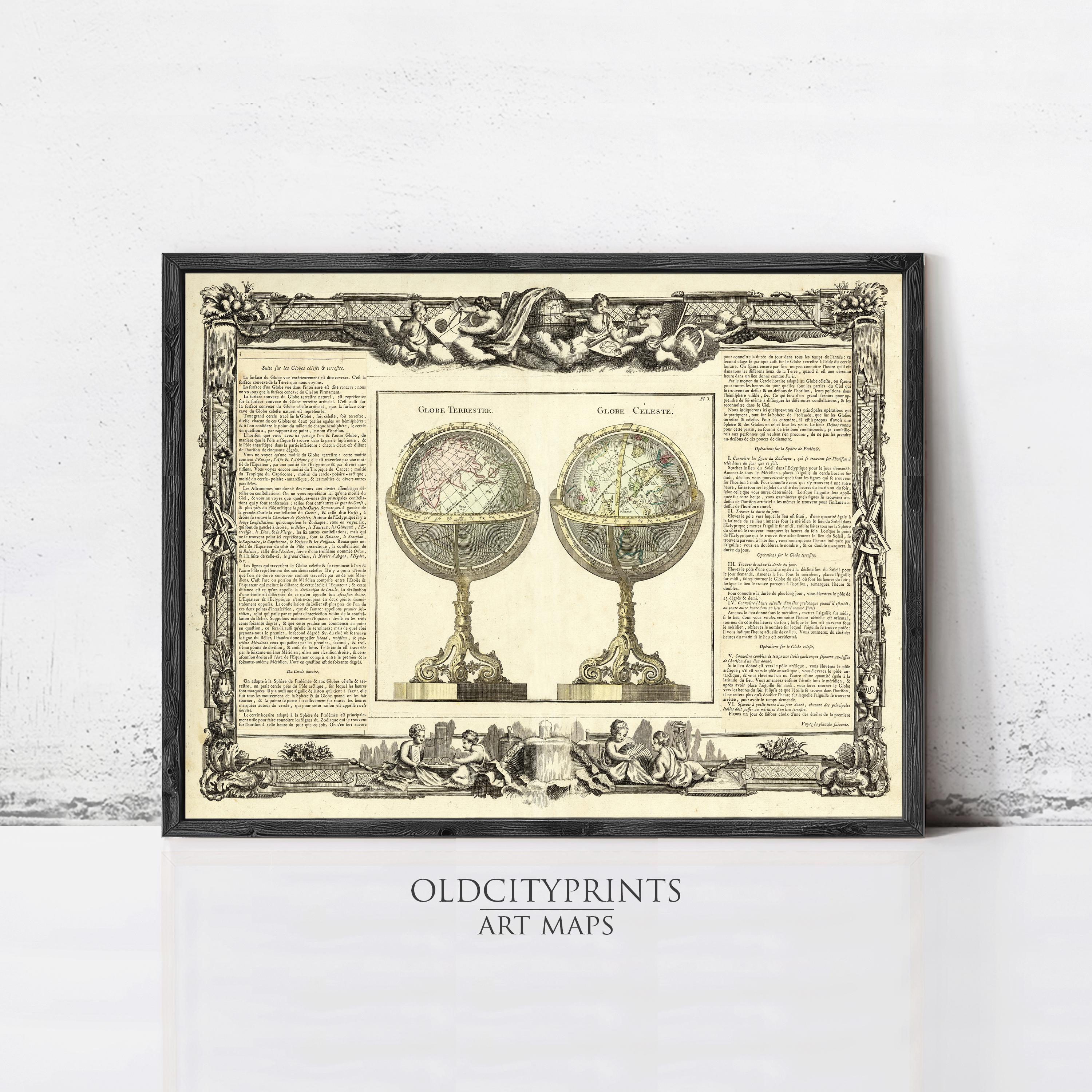 The image is a framed art print featuring two antique globes, one with a pinkish hue and the other with a greenish tint. The print is framed with an ornate border and is displayed on a white wall.