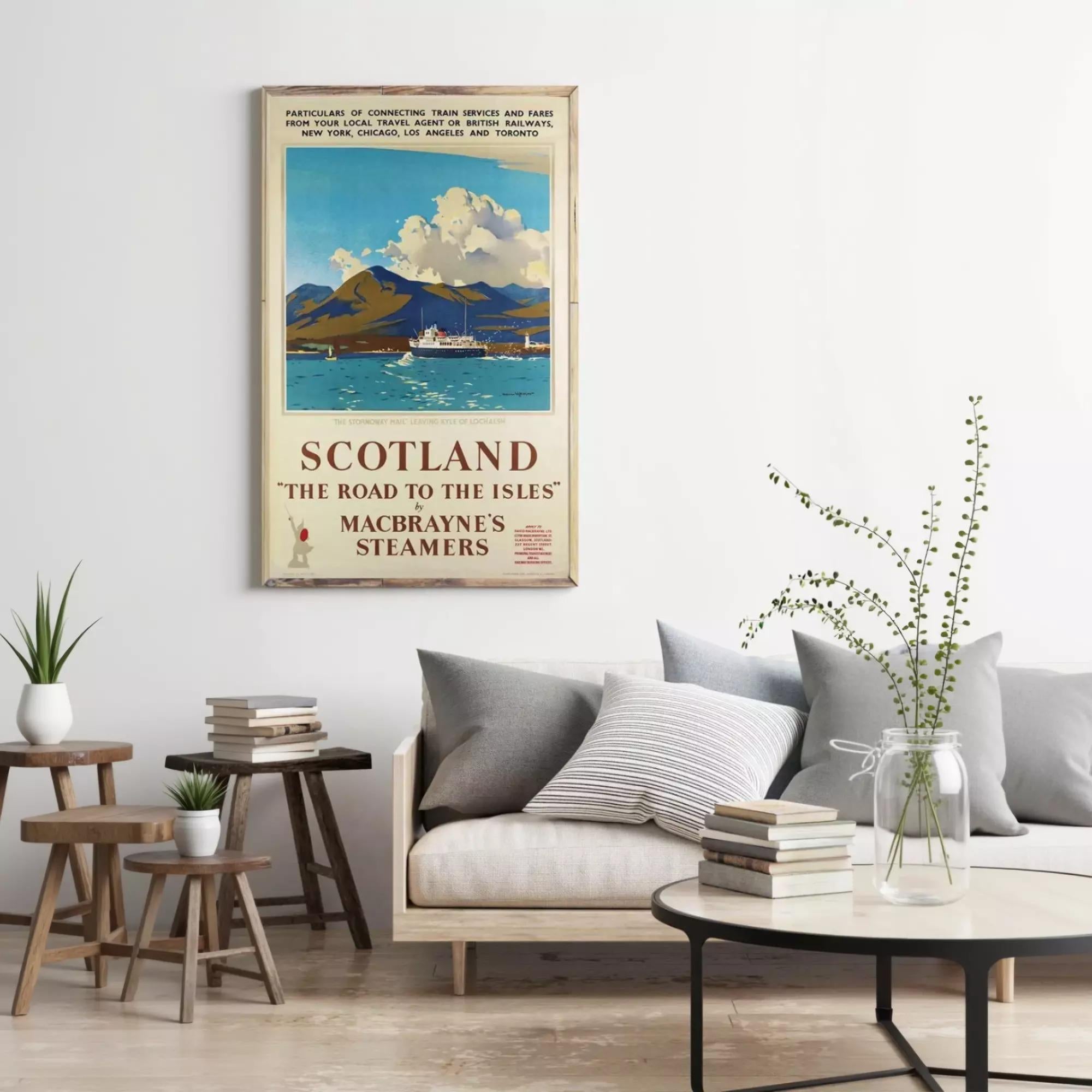 a vintage travel poster of Scotland, hanging on a wall above a couch and a coffee table in a living room setting.